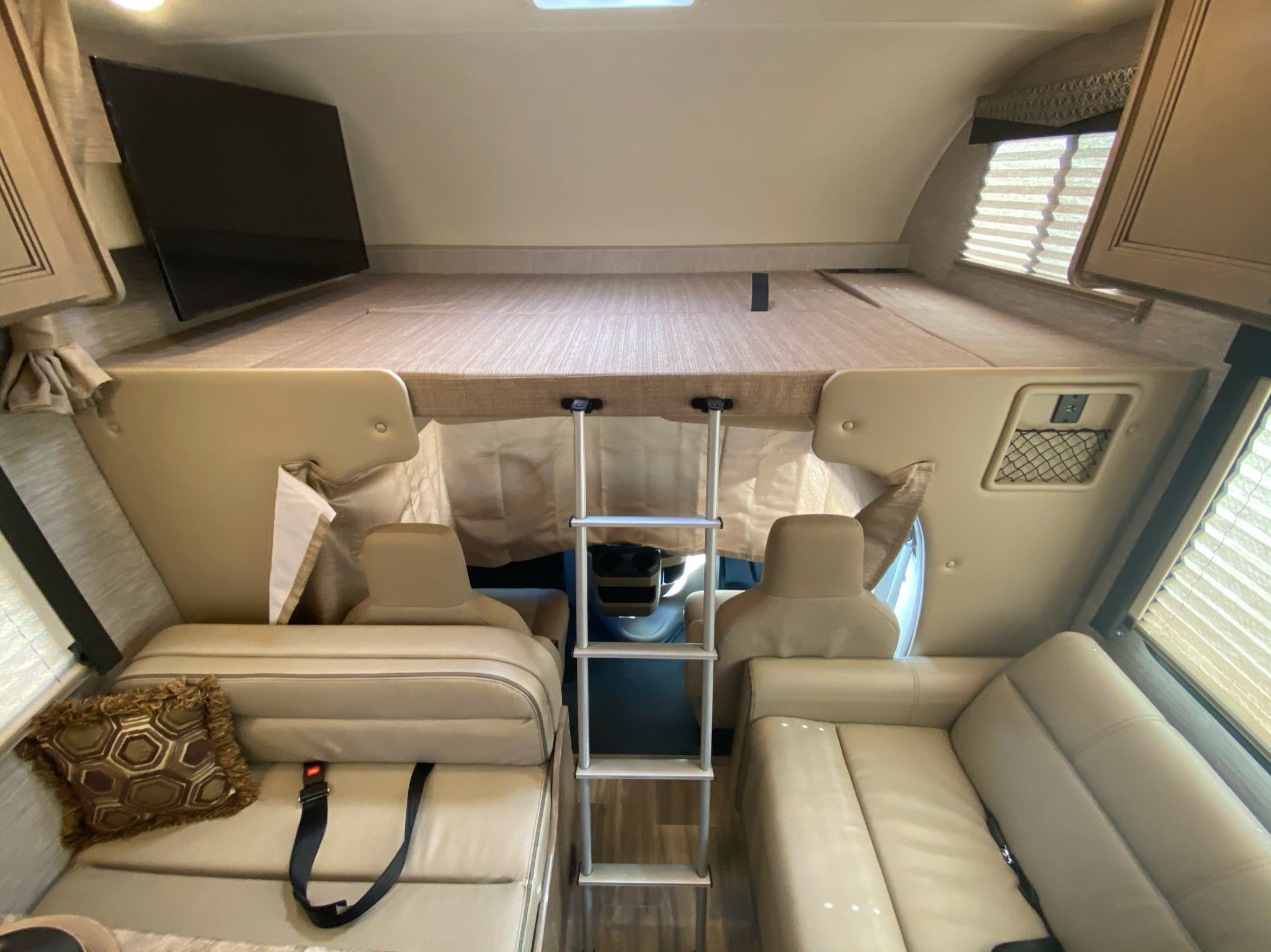 Explore this comfy rv rental with an over-cab bed, ladder access, sofa seating, and a TV. Your next adventure awaits!. Other Four Winds 2021