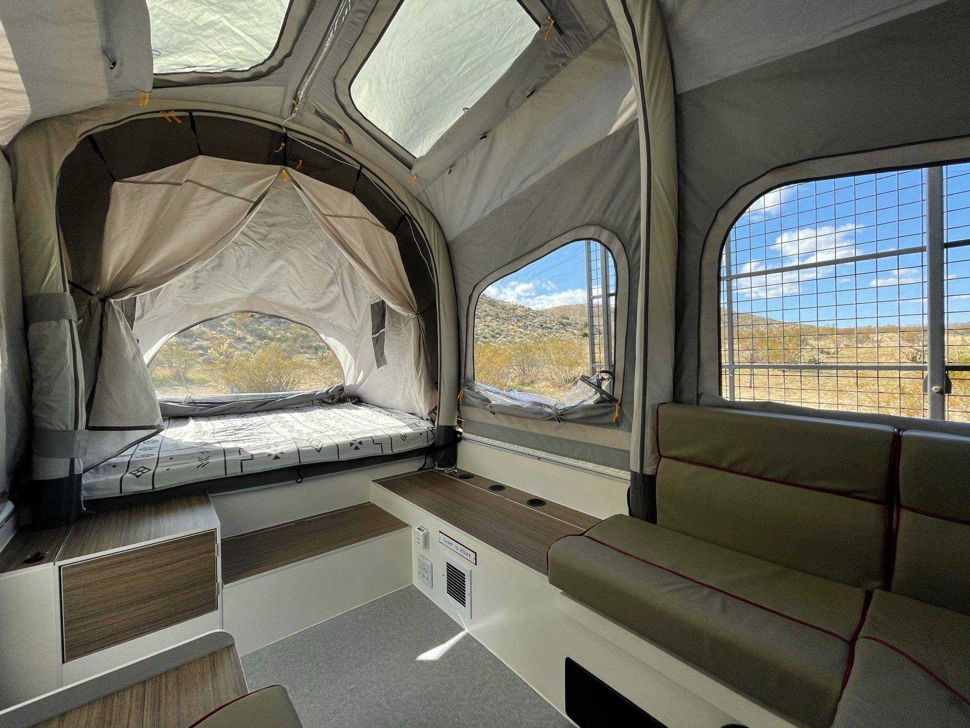 Explore nature with this RV rental! Spacious pop-up camper interior features a bed, seating, and desert views.. Opus OP4 Off Road 2020