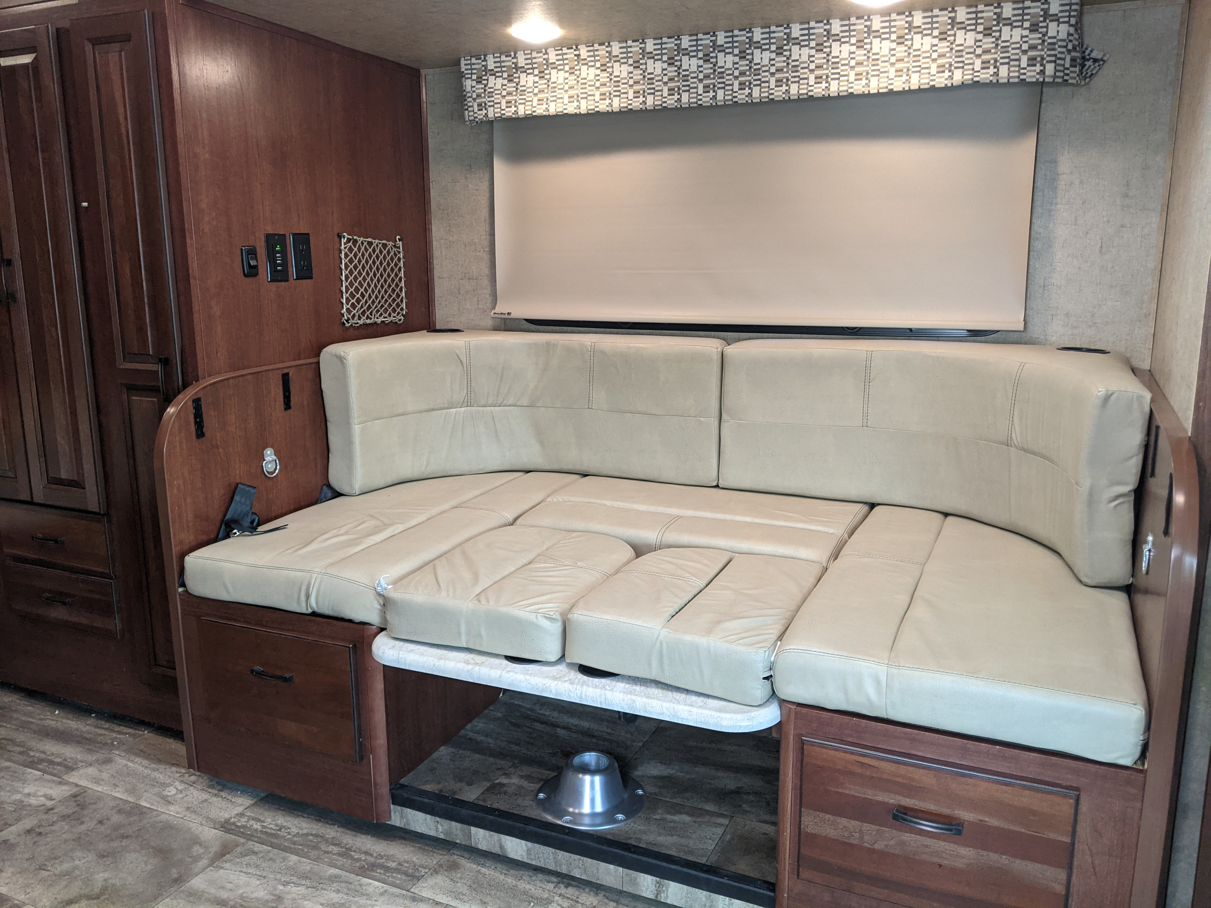 Light-cushioned dinette area in an RV rental, designed to convert into a comfortable bed for your travels.. Forest River Sunseeker 2016