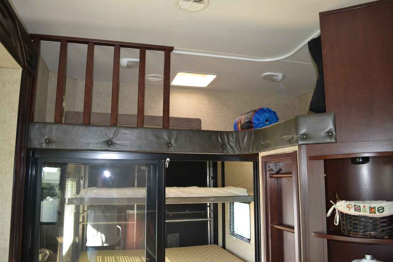 Inside this RV rental: multiple bunk beds below a cozy loft bed provide great sleeping for families.. Heartland Cyclone 2014