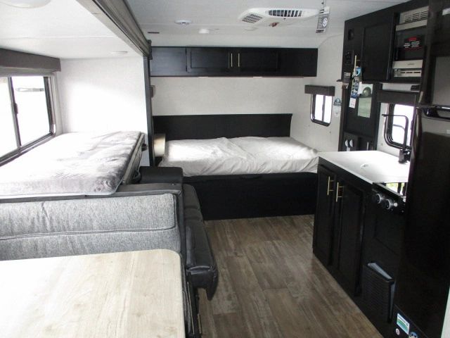 This modern rv rental boasts a full kitchen, a comfortable bedroom, and a sofa bed in the living area.. Forest River Wolf Pup 2021