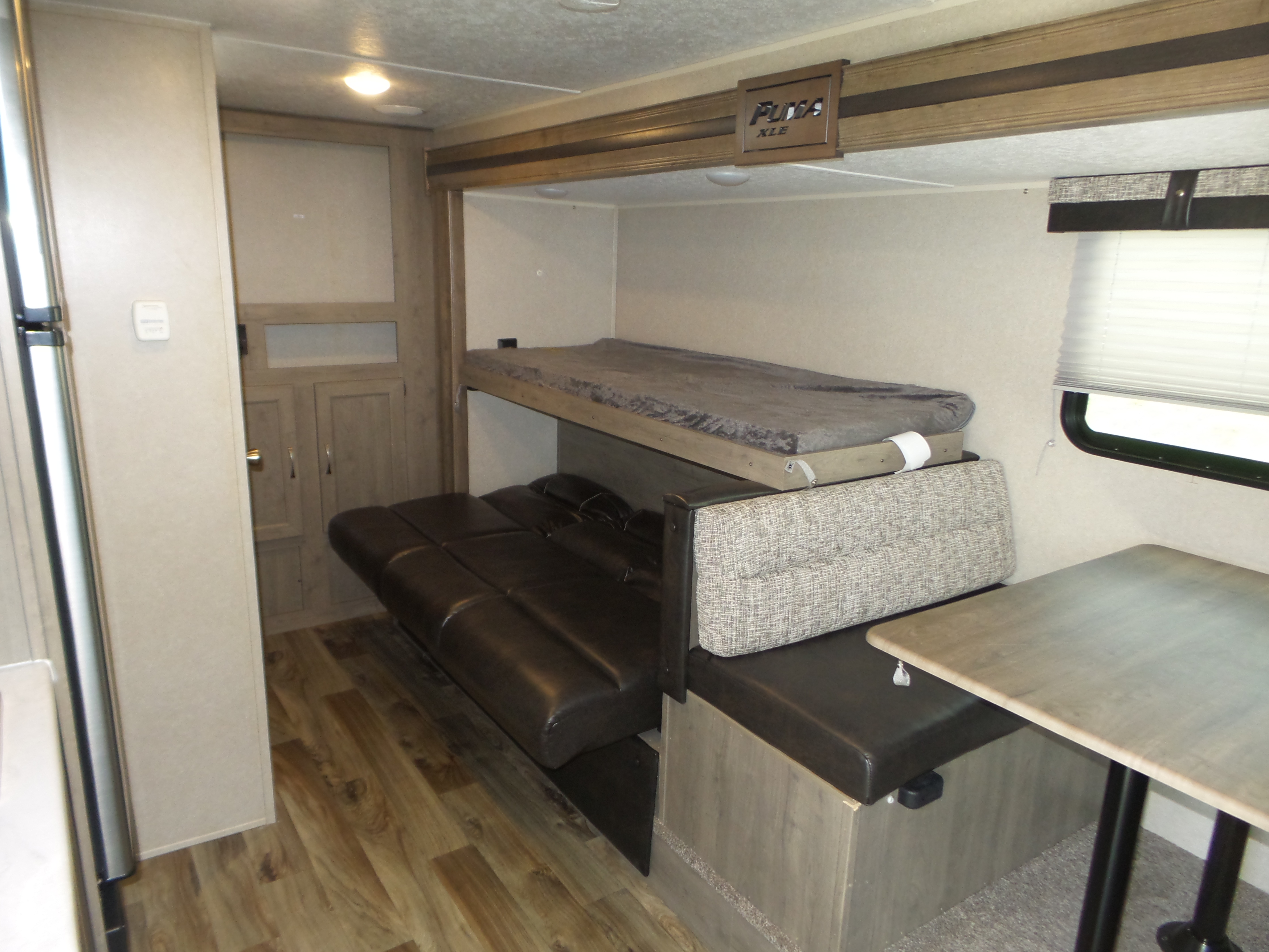 RV rental interior: bunk beds, convertible sofa, dinette, and kitchen area for comfortable travel.. Palomino 18SSX 2019