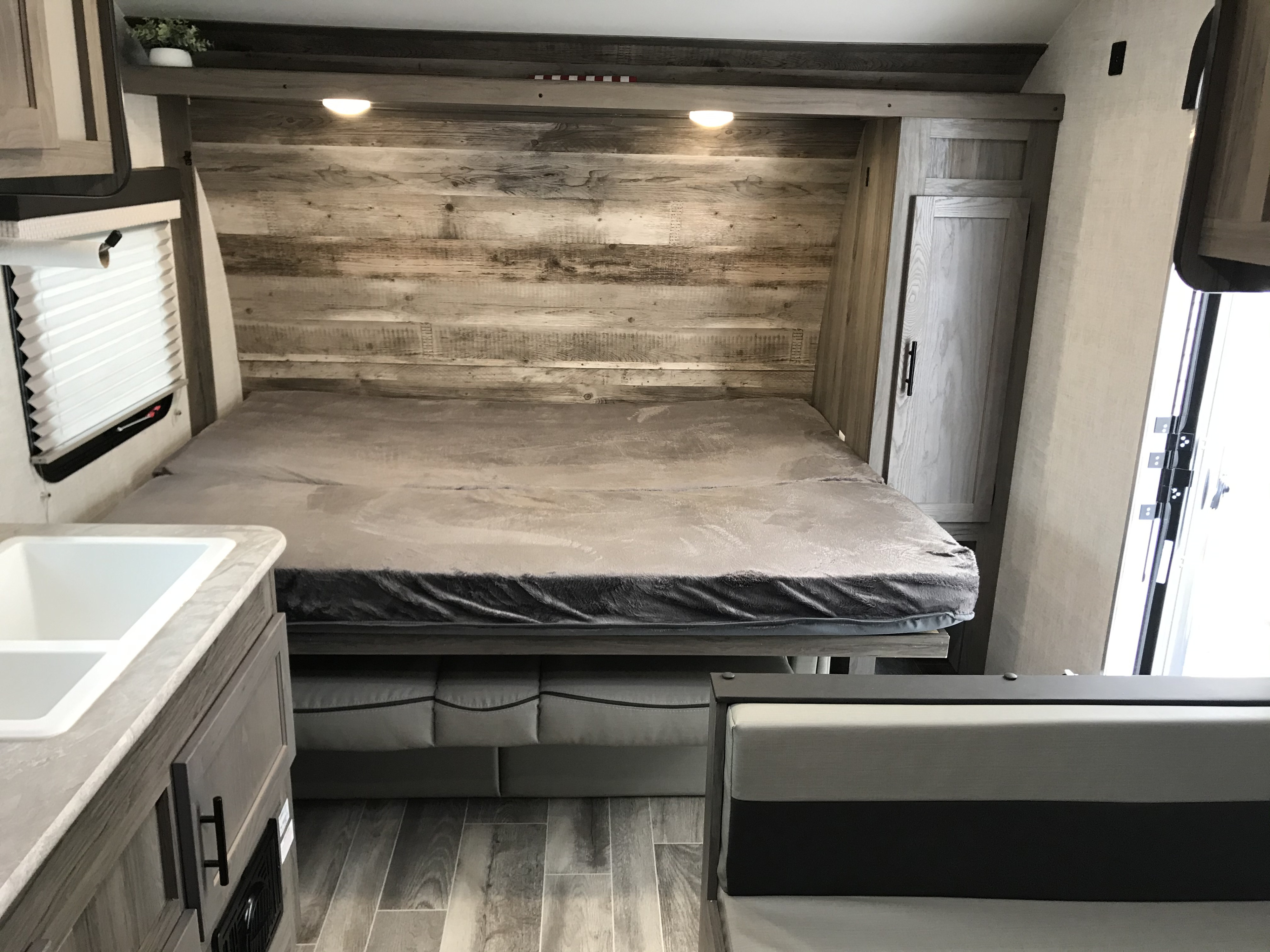RV rental: Spacious interior showing a Murphy bed, kitchenette, and dinette with modern finishes.. Gulf Stream Amerilite 2021
