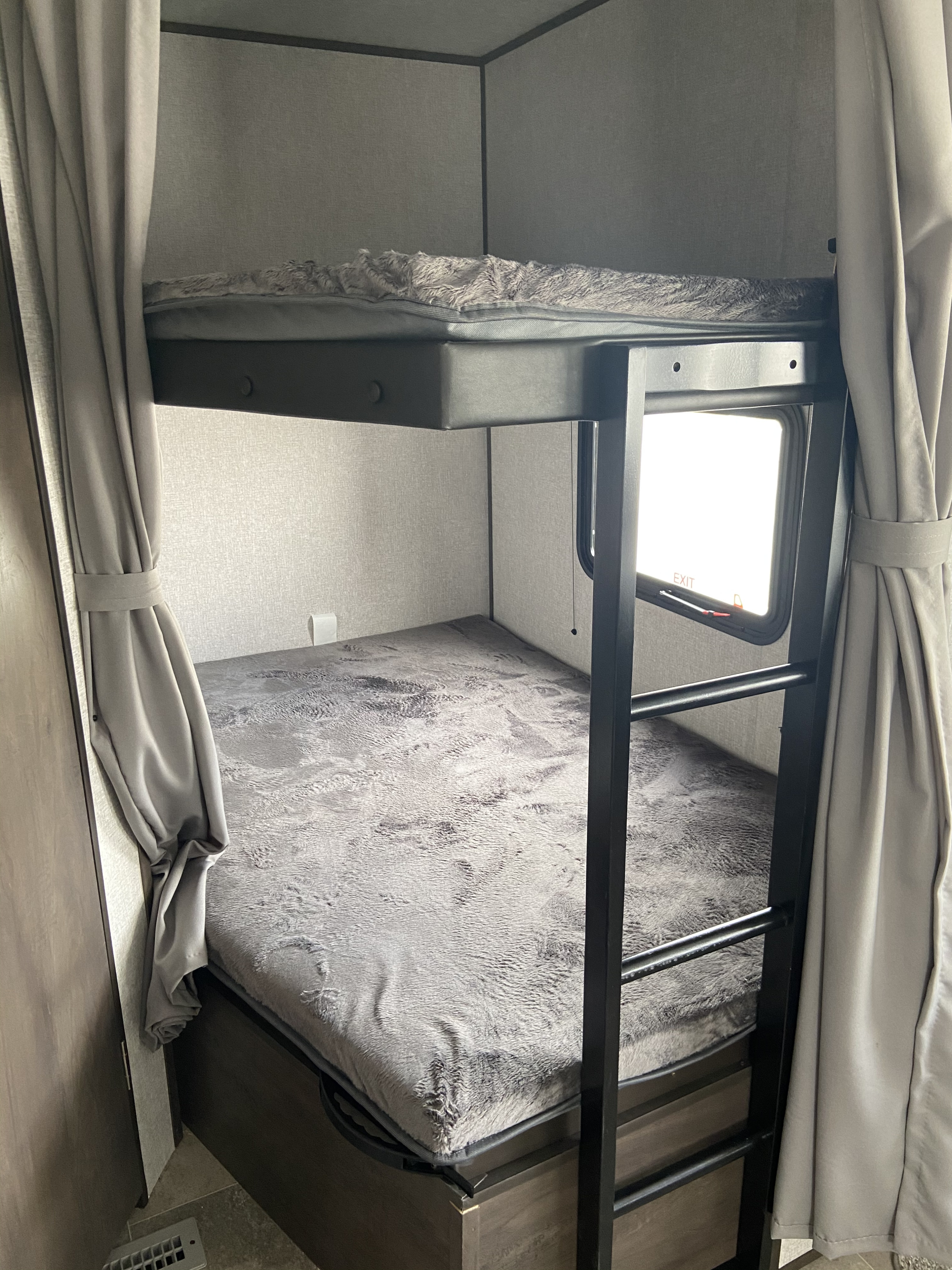 RV rental interior featuring cozy bunk beds with a ladder and window, ideal for compact sleeping space.. Coleman 263bh 2021