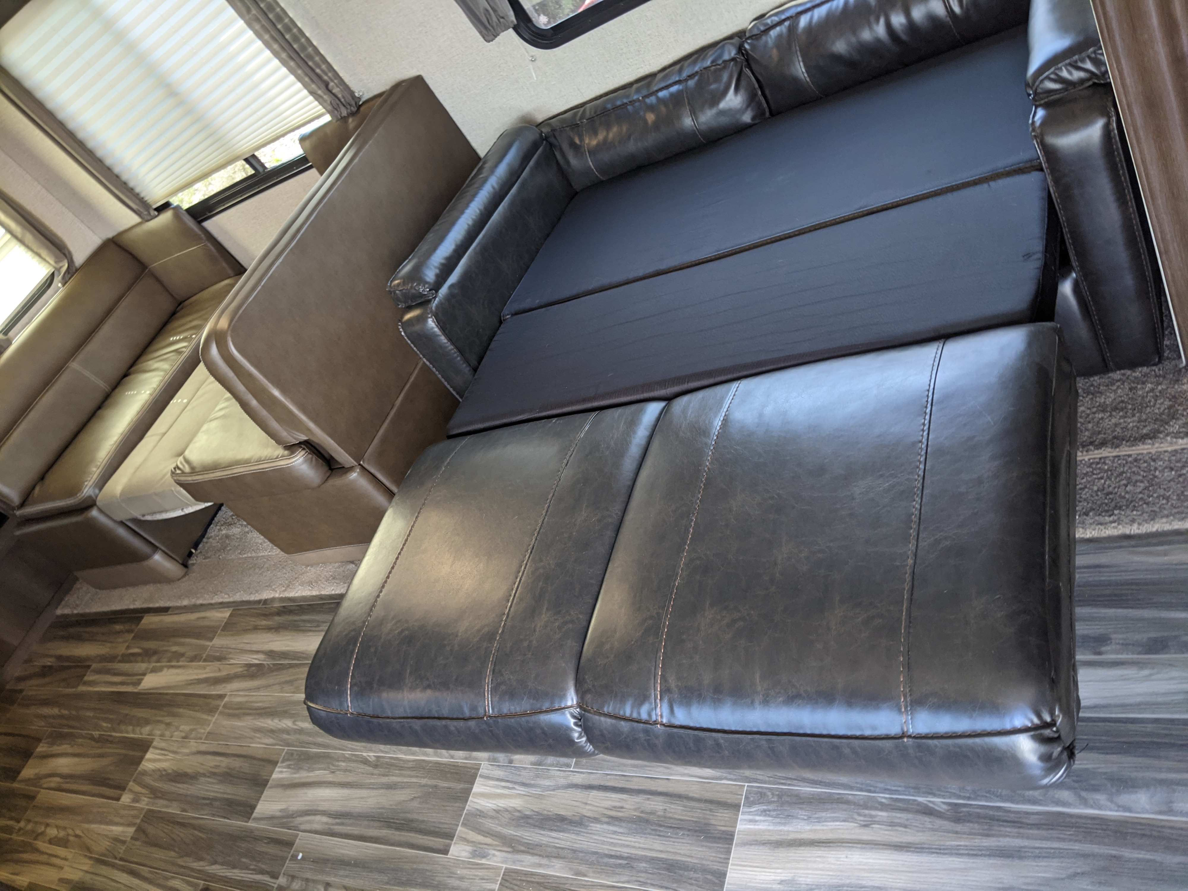 RV rental interior featuring a versatile convertible sofa bed and dinette, offering flexible seating and sleeping space.. Shasta Oasis 2019