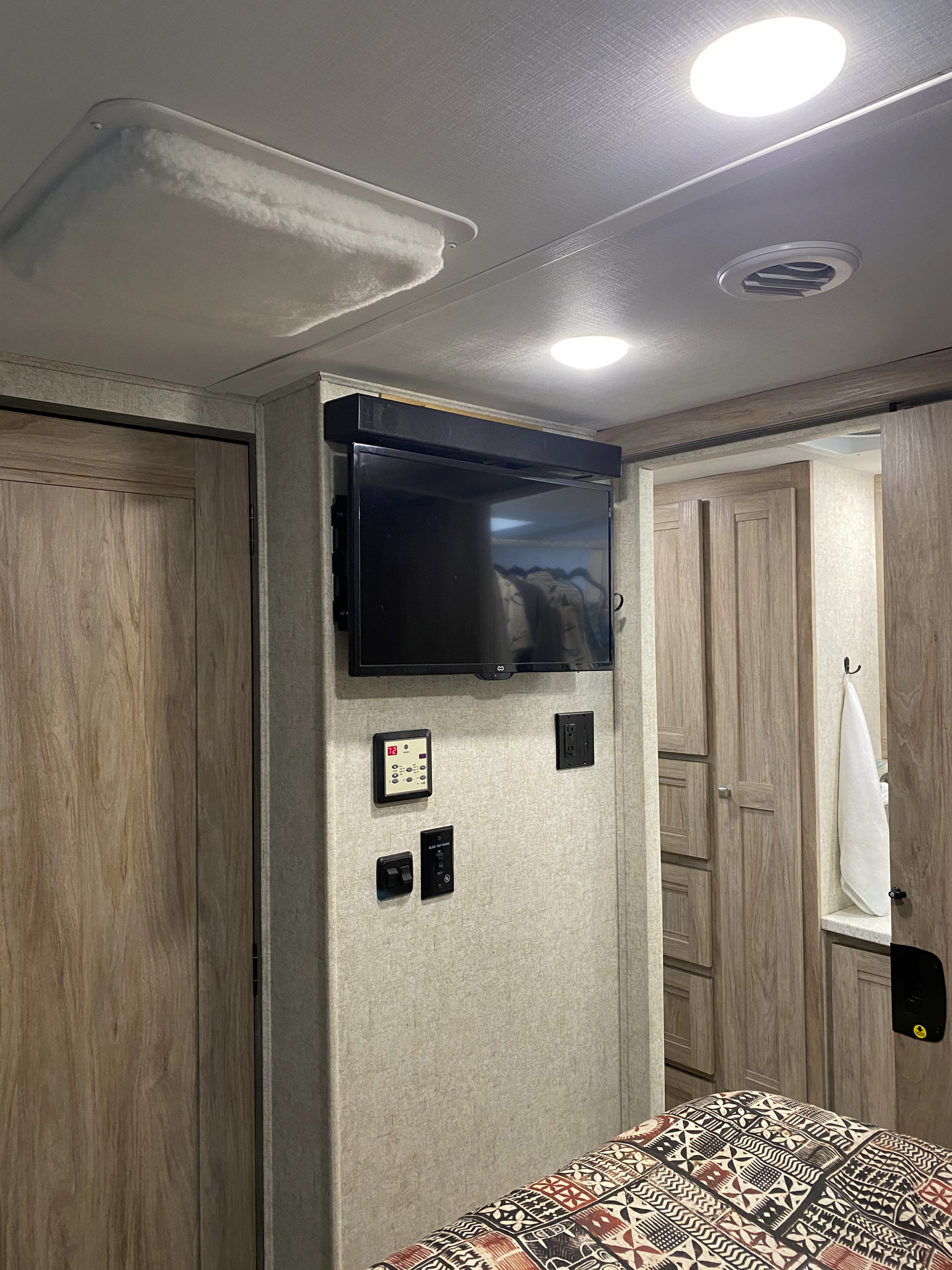 The flat panel display has an Apple TV and sound bar for great picture and sound.  This view is from the bed for snuggling up watching a movie.. Forest River Forester 2020