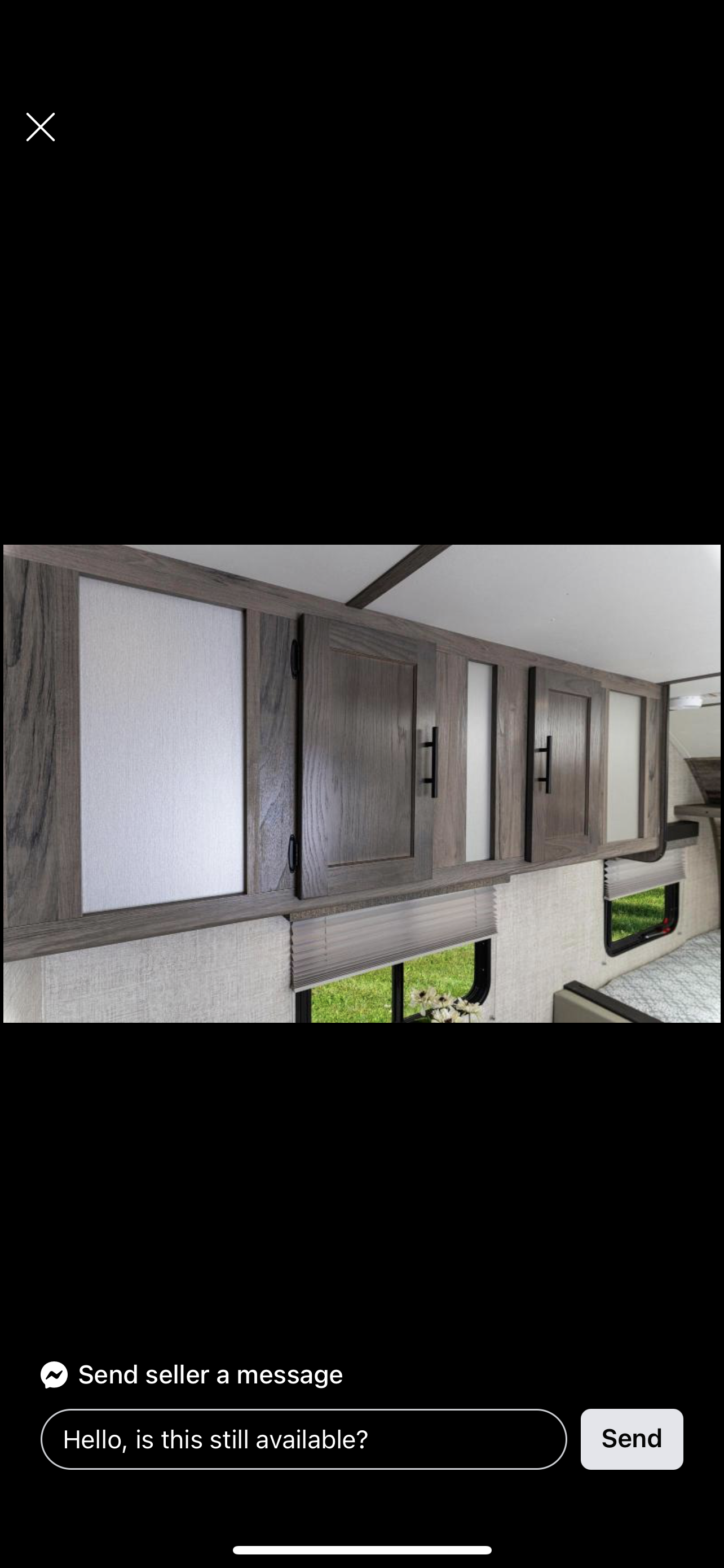 Detailed view of an RV's modern interior: wood-grain cabinets, frosted panels, window blinds, and bed. Great for an rv rental.. Gulf Stream Amerilite 2021