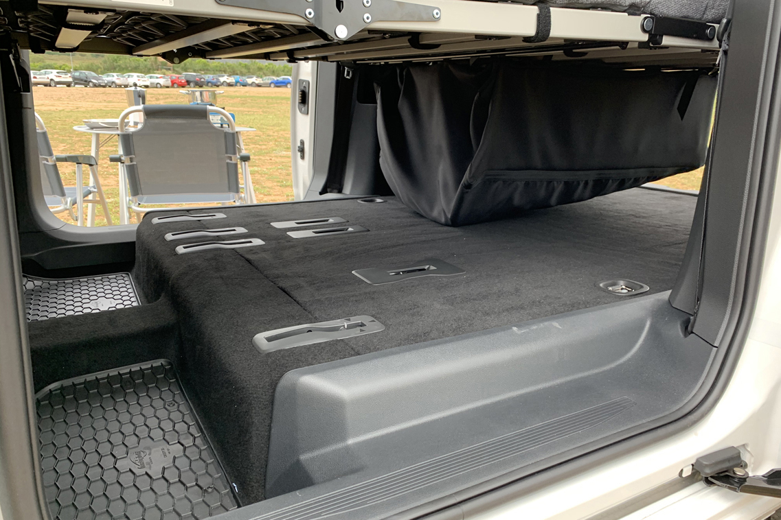 RV rental camper's interior: Versatile space with foldable bunk/storage and floor tie-downs, ready for adventure.. Volkswagen Caddy 2021