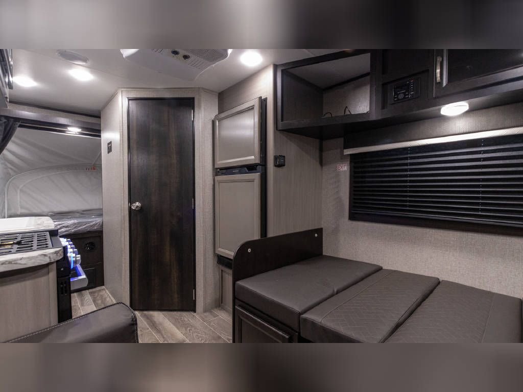 Explore the comfortable and modern interior of this RV rental, featuring a compact kitchen, living space, and bed area.. Jayco Jay Feather 2021