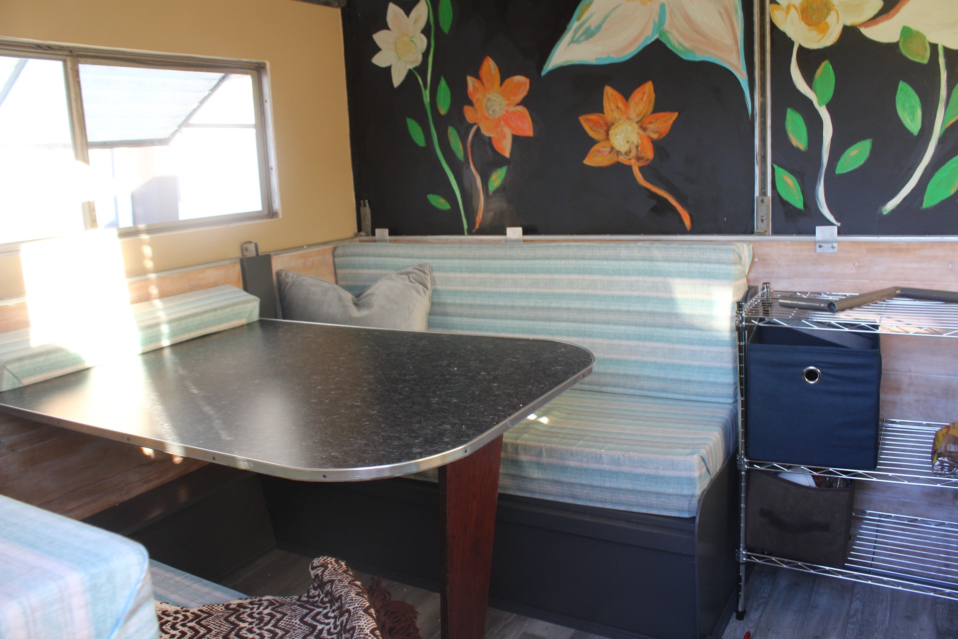 This is the fold-down dinette. The cushions are this and comfortable! Window with screen. Metal rack and bins for storage. . Hi-Lo CT 1961