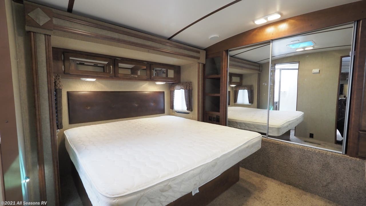 Spacious RV rental bedroom with a large bed, mirrored closet, and ample storage.. Keystone Outback 2016