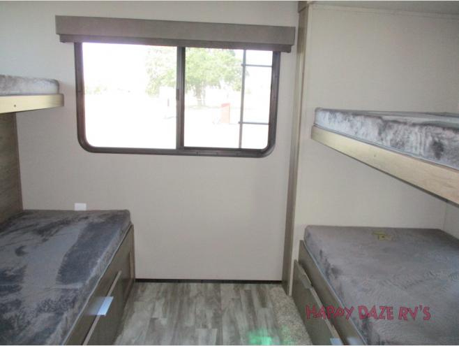RV rental sleeping area featuring multiple bunk beds & a large window. Great for families.. Grand Design IMAGINE 3250BH 2021
