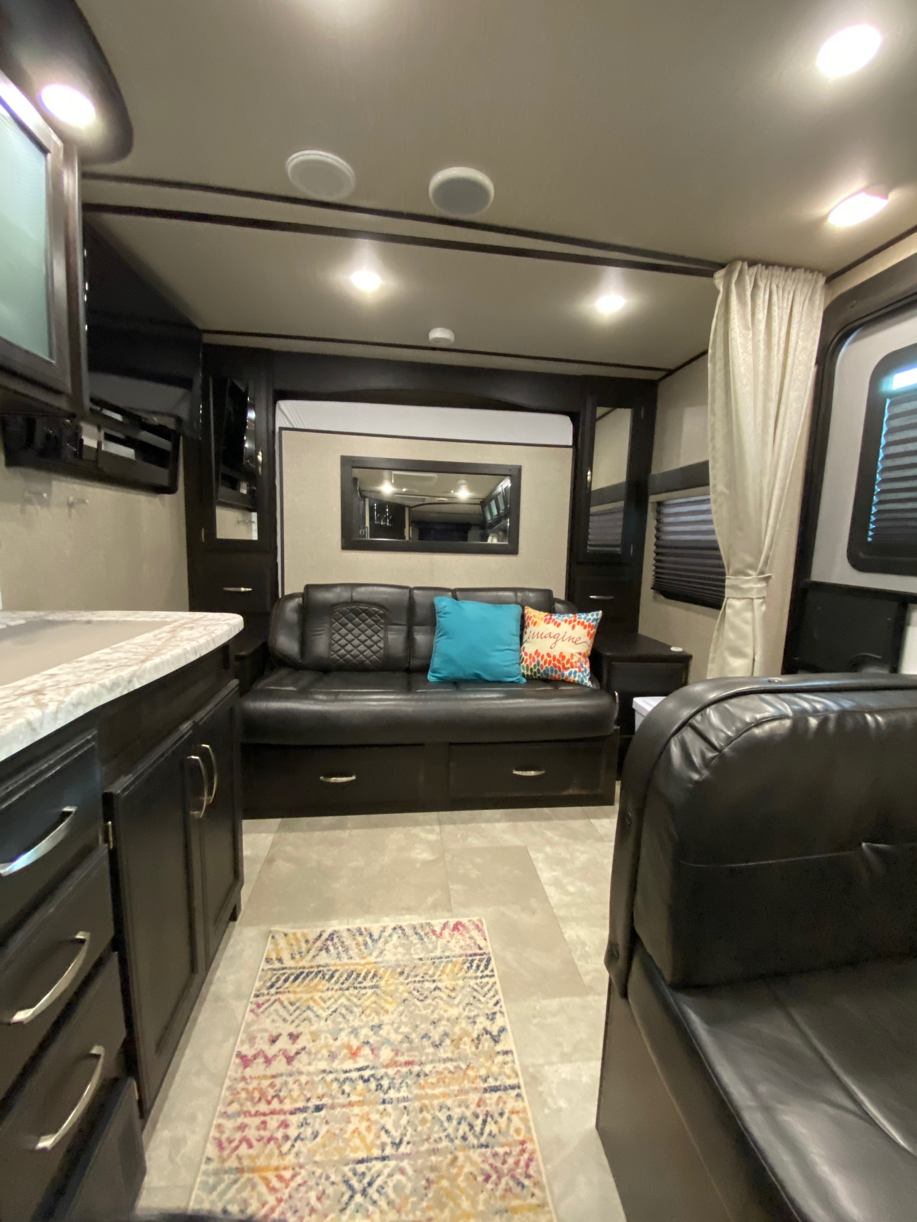 When you raise the murphy bed there is a great couch to relax on.. Grand Design Imagine XLS 21BHE 2020