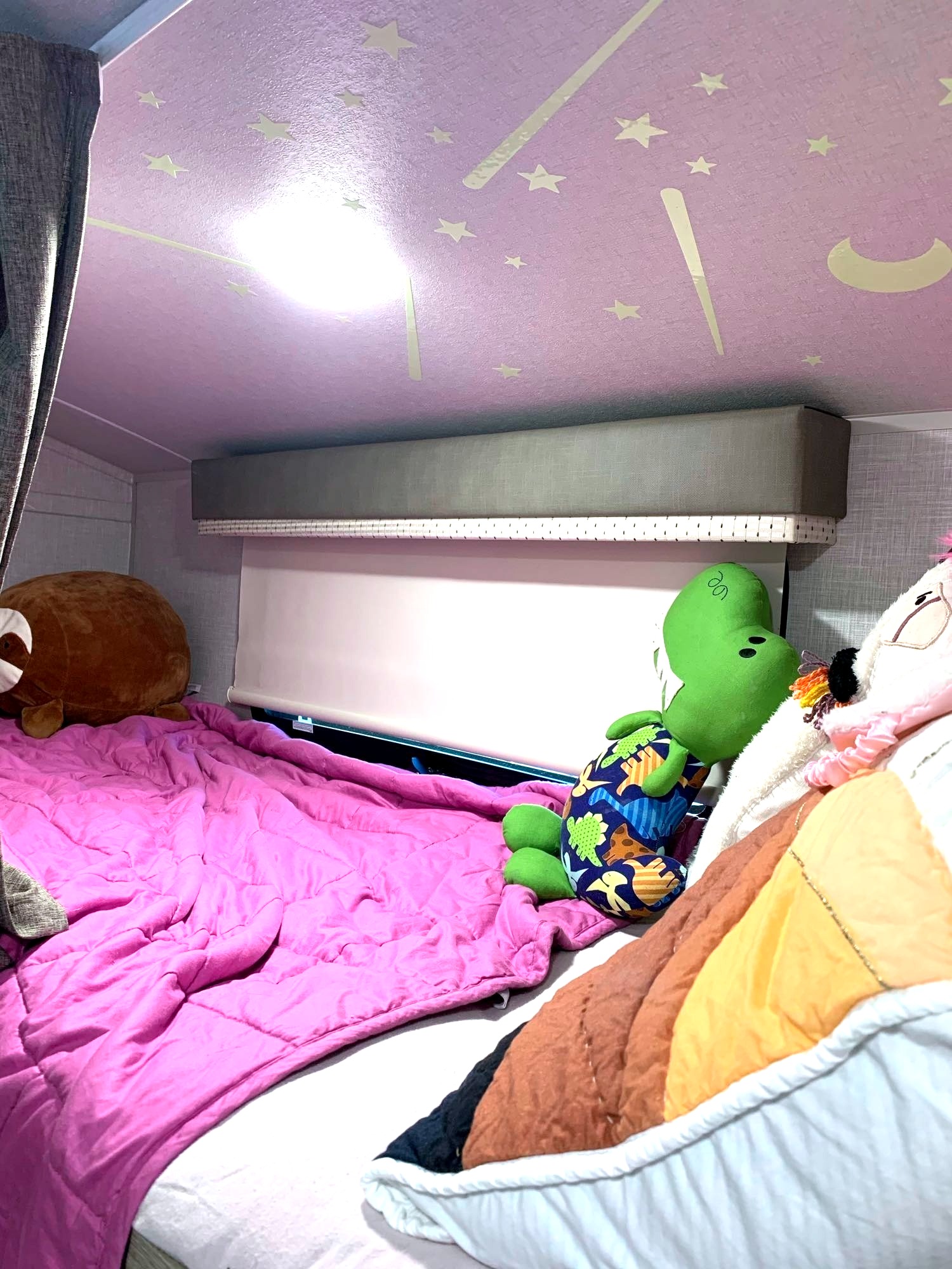 Cozy RV rental bunk bed for kids, featuring glow stars, bright light, and plush toys. Perfect for family adventures.. Forest River Other 2021