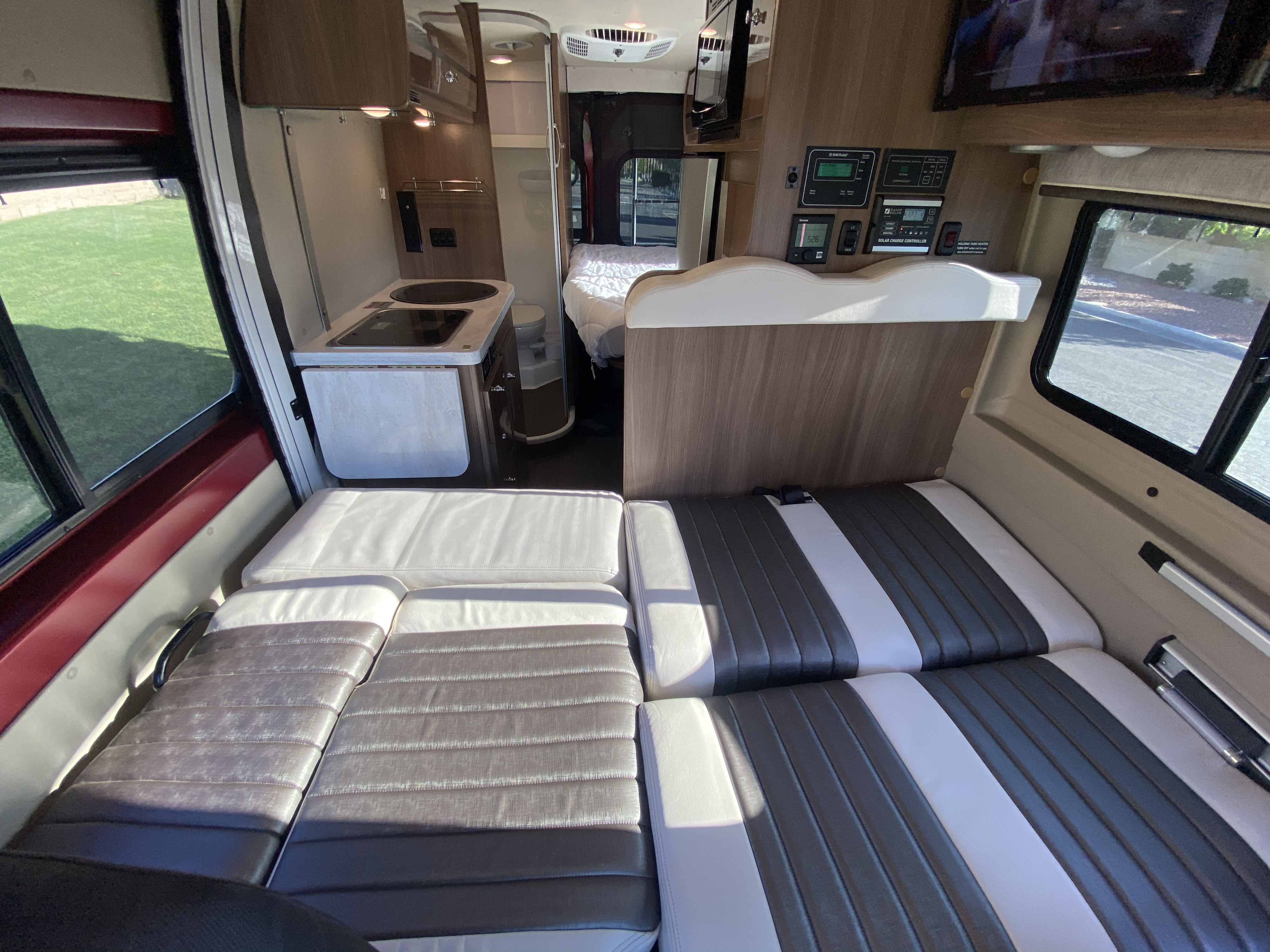 RV rental interior: Versatile living area with configurable seating/beds & compact kitchen.. Winnebago Travato 2018
