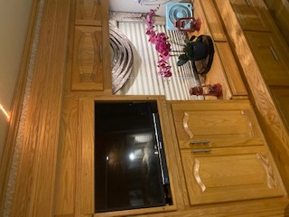 Experience this RV rental's interior: extensive wood cabinetry, built-in TV entertainment, and thoughtful decor.. Newmar Mountain Aire 2005