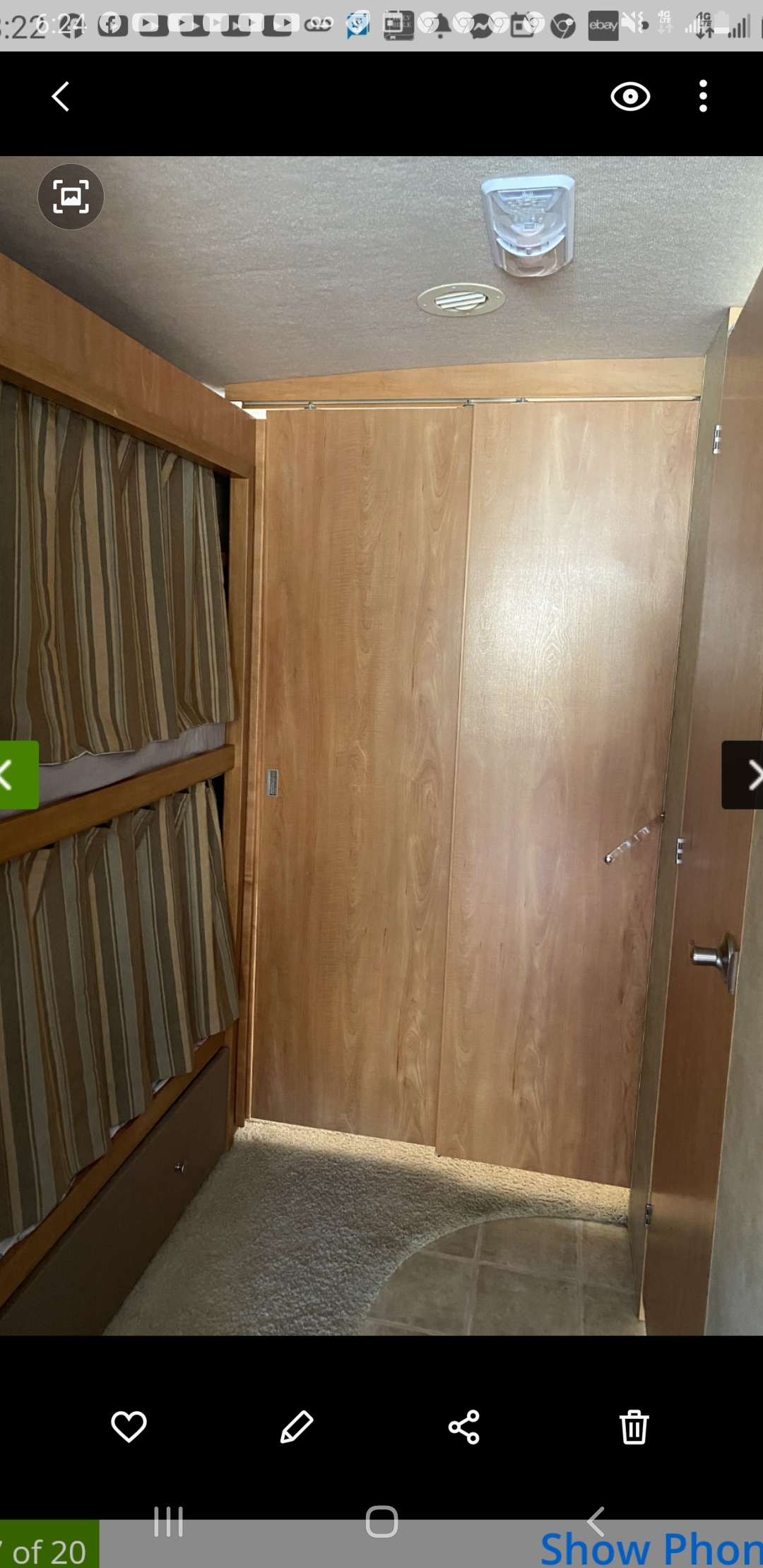 RV rental interior showing bunk beds with curtains, light wood sliding doors, and ceiling features.. Winnebago Vista 2009