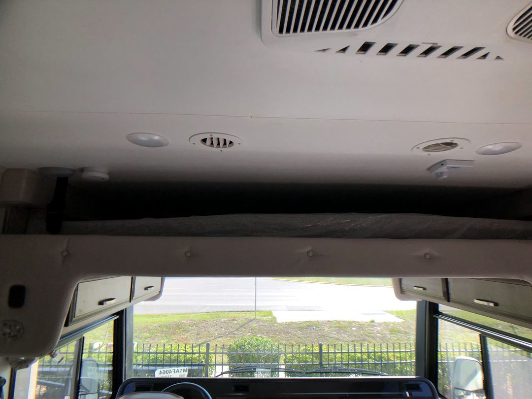 This RV rental features a comfortable overhead bunk, ceiling lights, and AC vents, offering a cozy motorhome interior.. Jayco Alante 2021