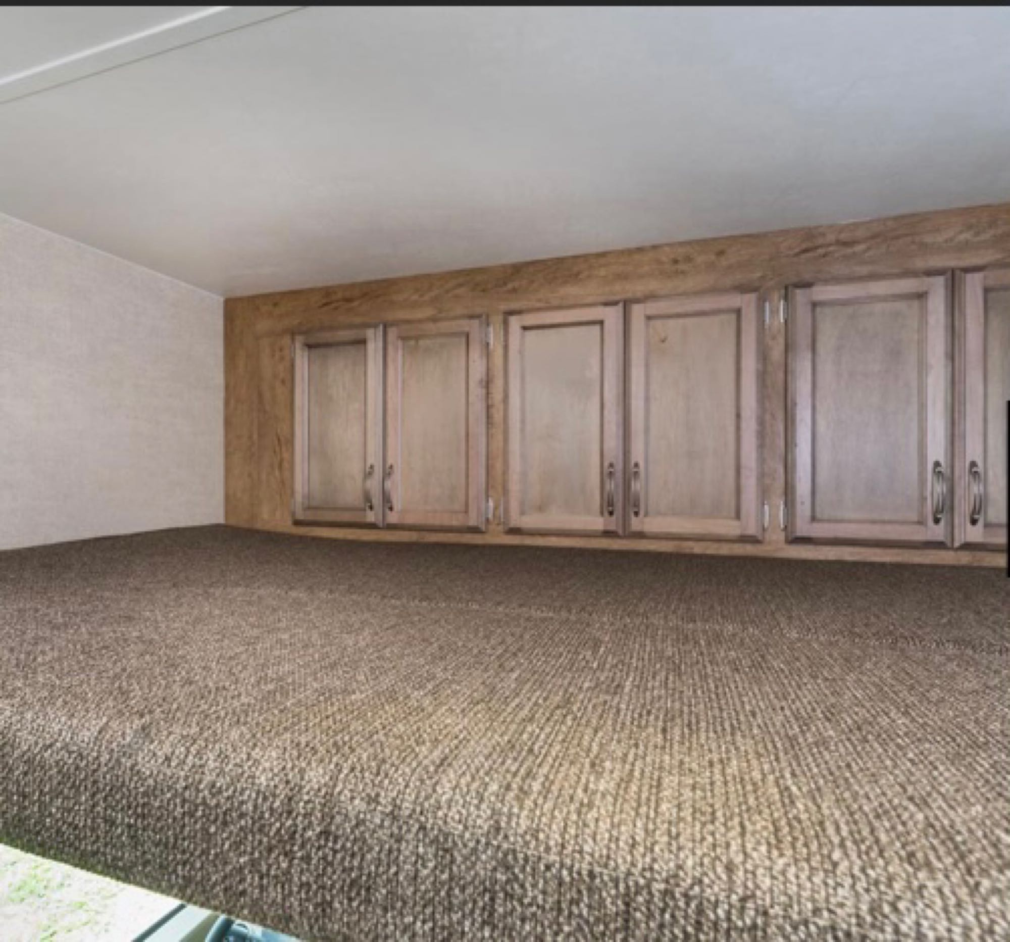 RV rental: Elevated sleeping platform with textured brown carpet and light wood overhead storage cabinets.. Gulf Stream Conquest 2021