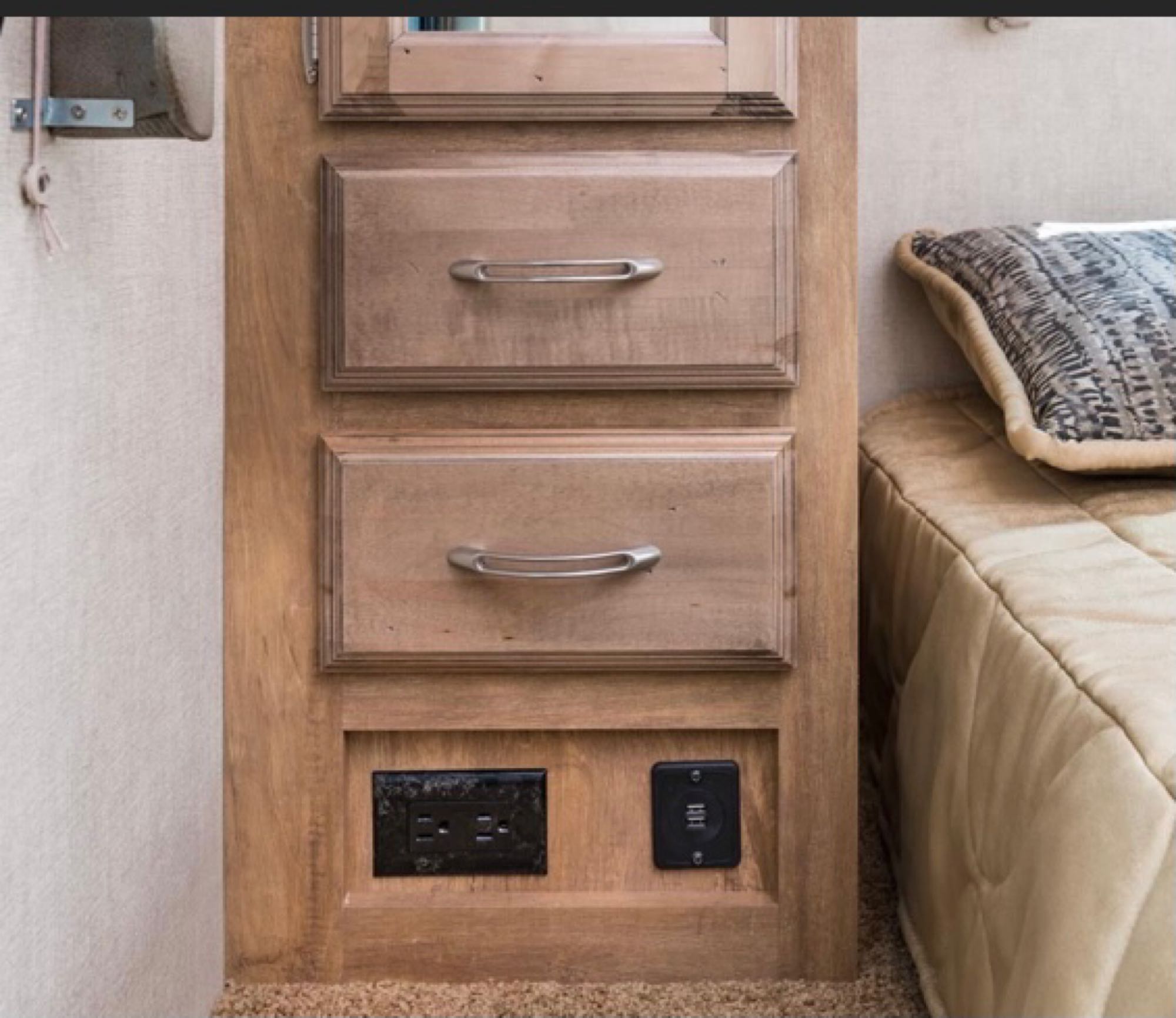 RV rental: Bedroom features wooden drawers, an AC outlet, and USB charging ports next to a bed.. Gulf Stream Conquest 2021