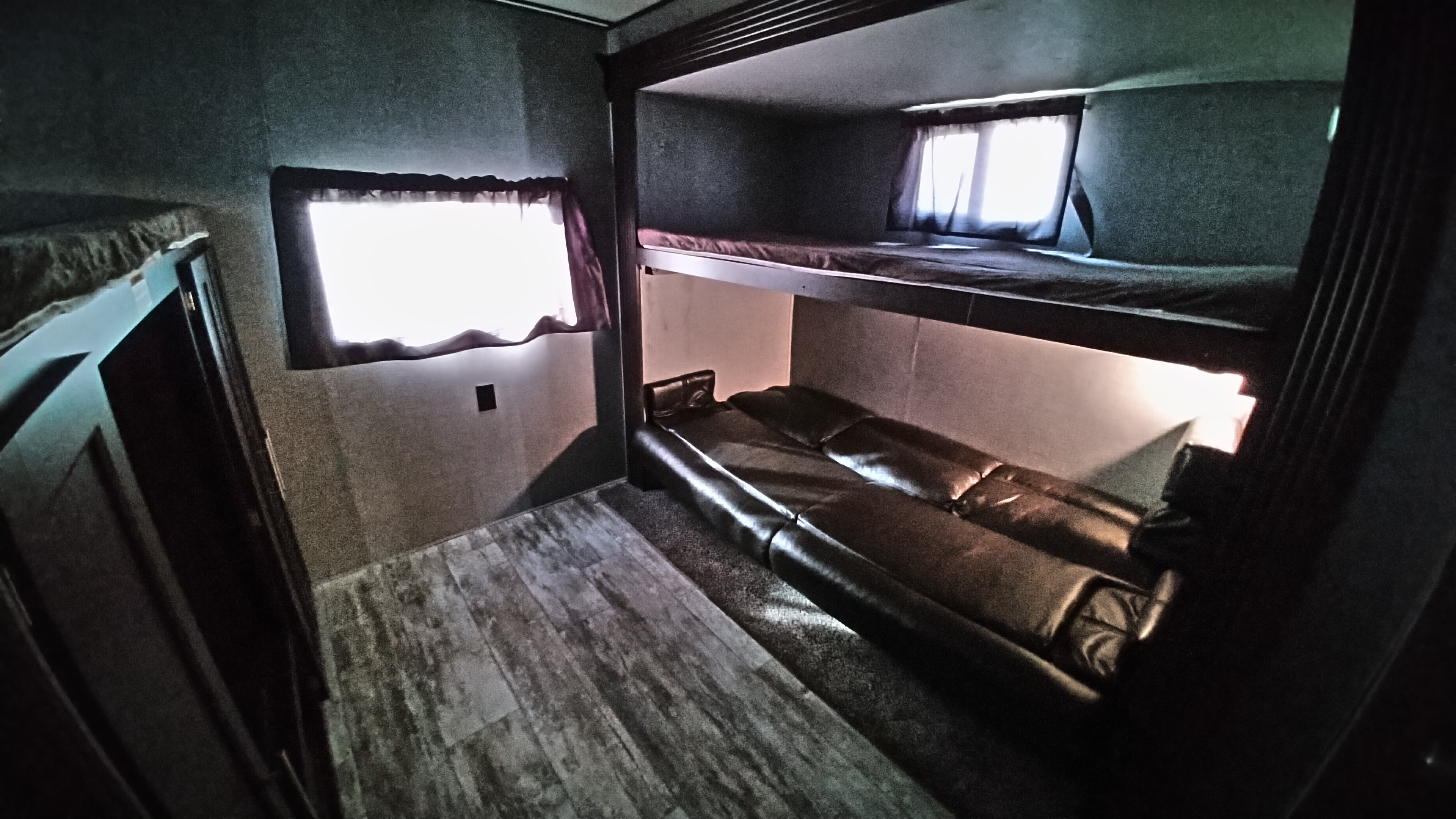 RV rental bunkhouse with comfy beds, a sofa, and sunlit window for a relaxing family trip.. Crossroads Zinger 2019