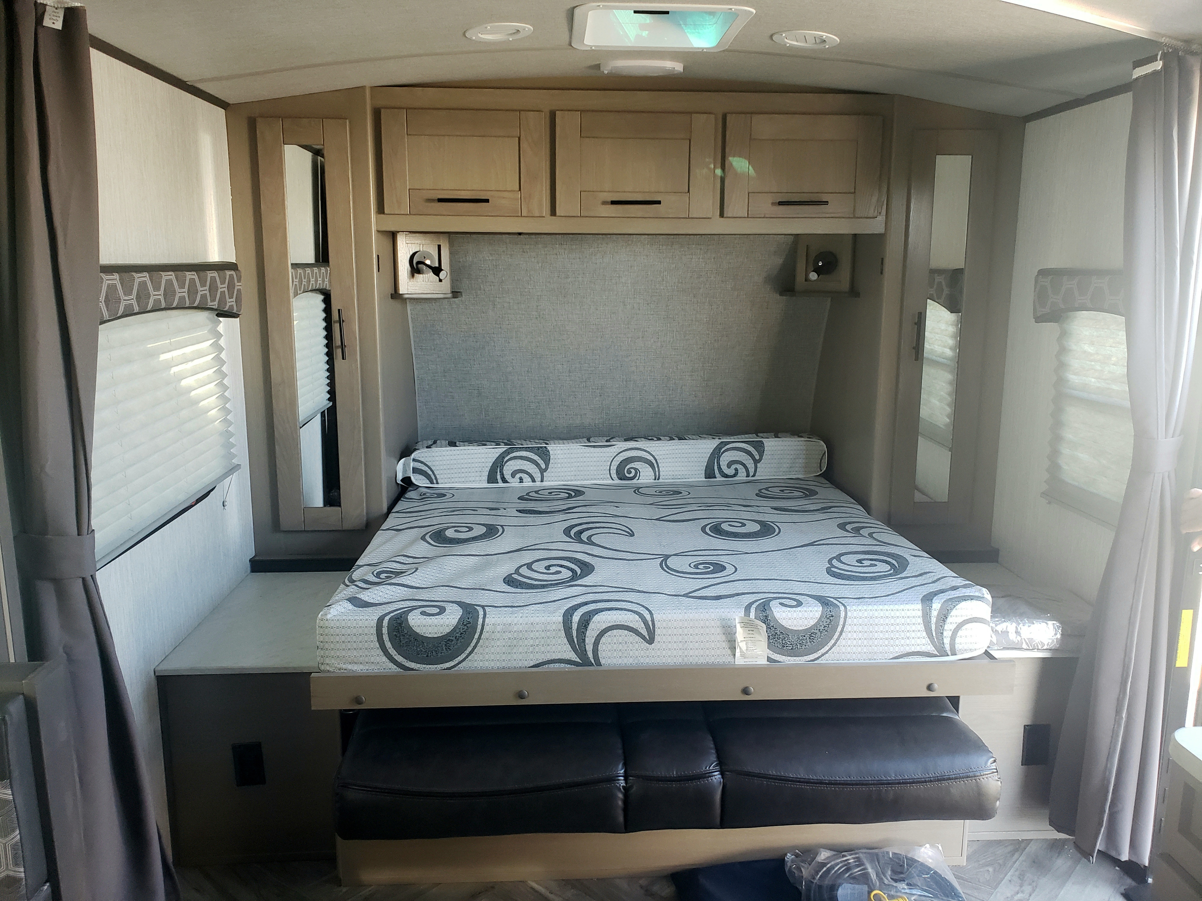 RV rental: Cozy bedroom with a convertible bed featuring a patterned mattress, overhead storage, and windows.. Cruiser Rv Corp Shadow Cruiser 2020