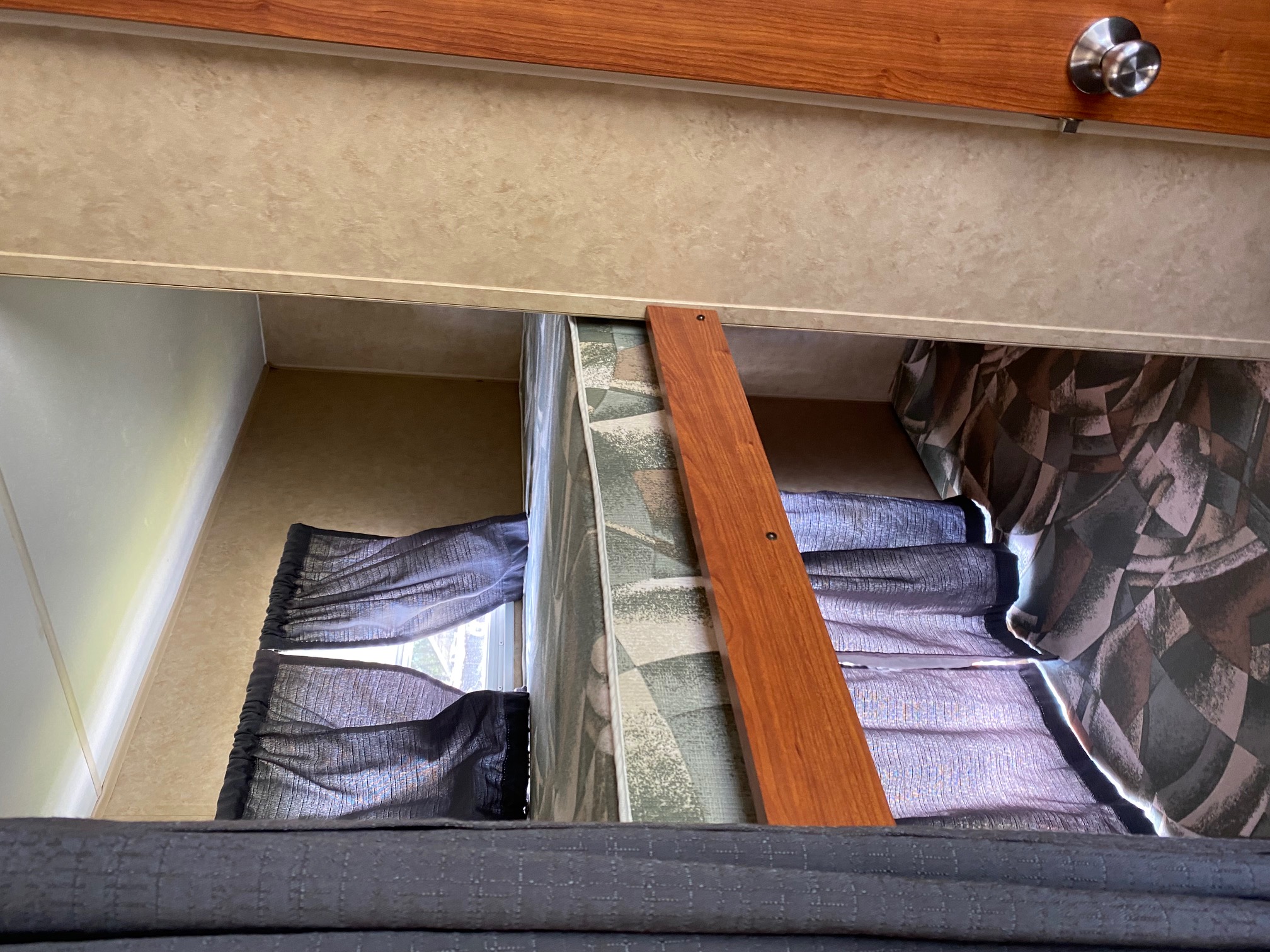 RV rental interior: stacked bunk beds with curtains, mattresses, and a wooden rail, offering compact sleeping space.. R-Vision Super Sport 26bhs 2009