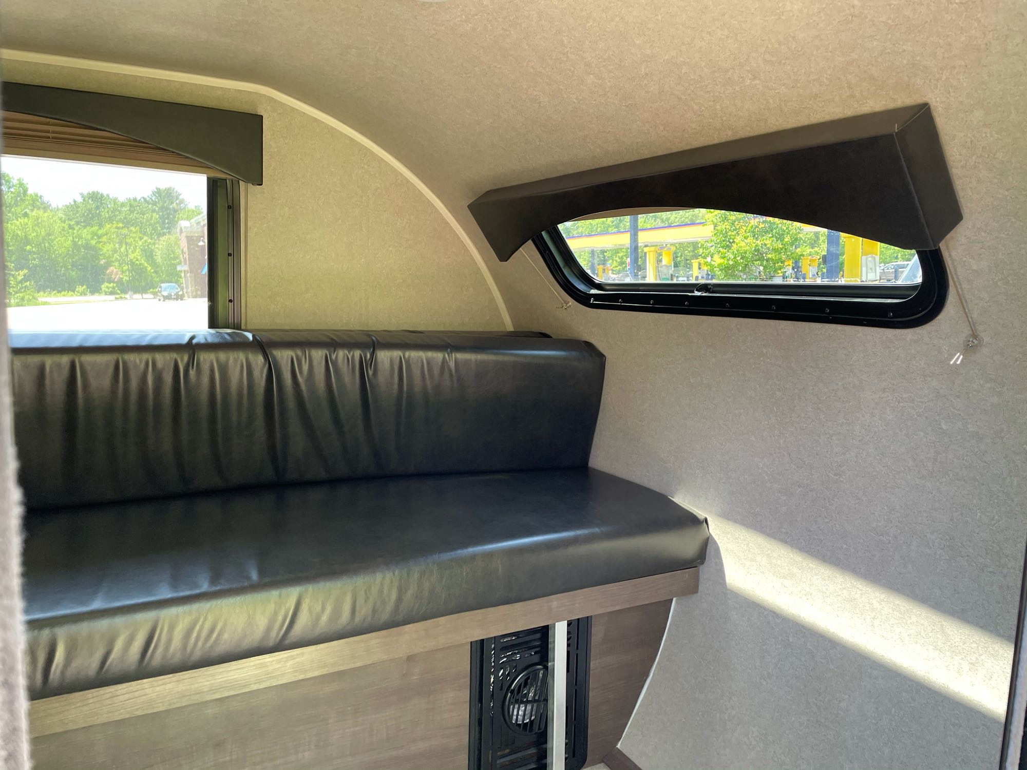 Spacious RV rental interior featuring a comfortable bench seat and bright windows for scenic views on your adventure.. Sunray Other 2021