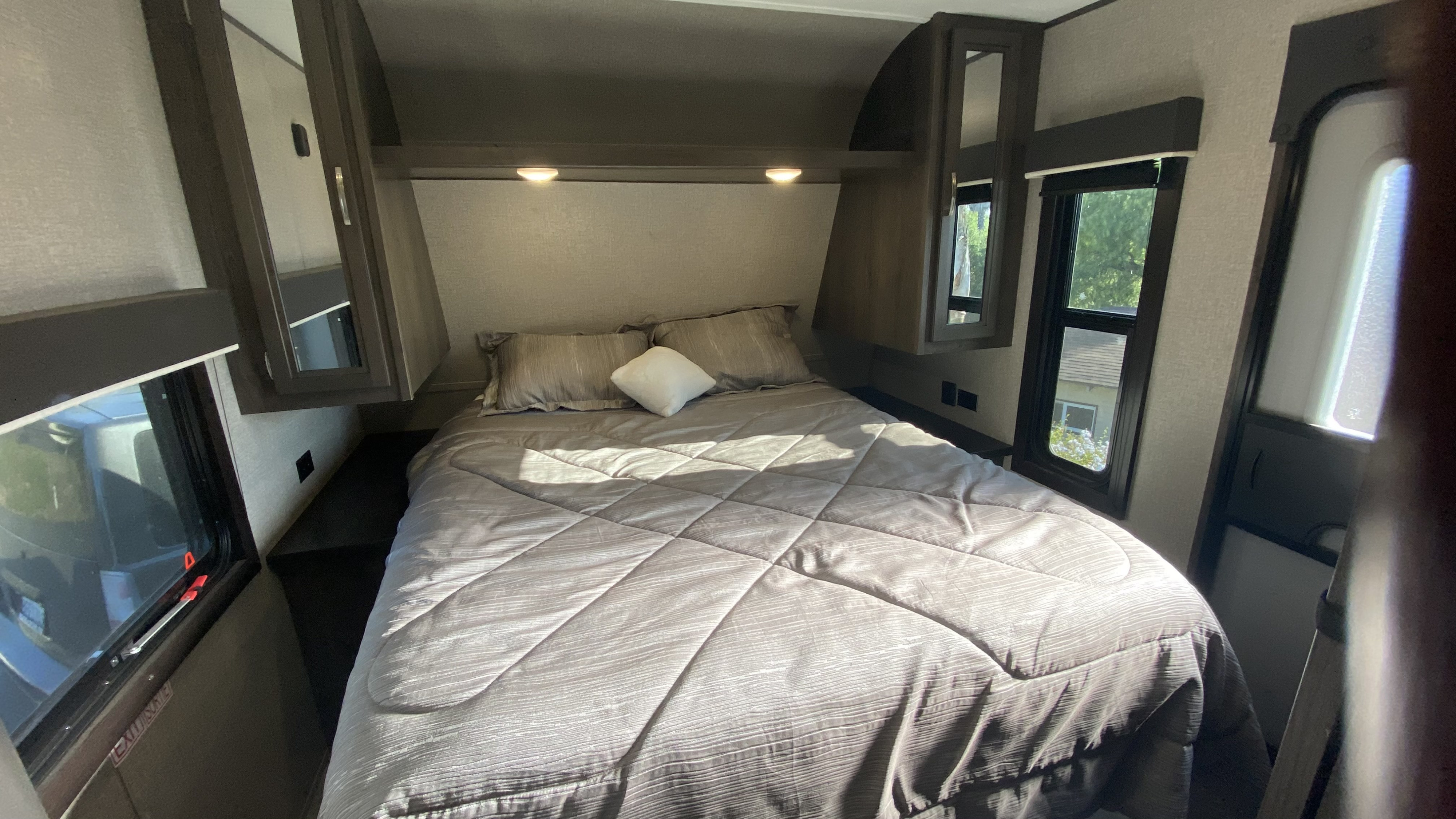 Step into comfort with this cozy RV rental bedroom. It features a large bed, ample storage, and bright windows.. Jayco Jay Flight 2020