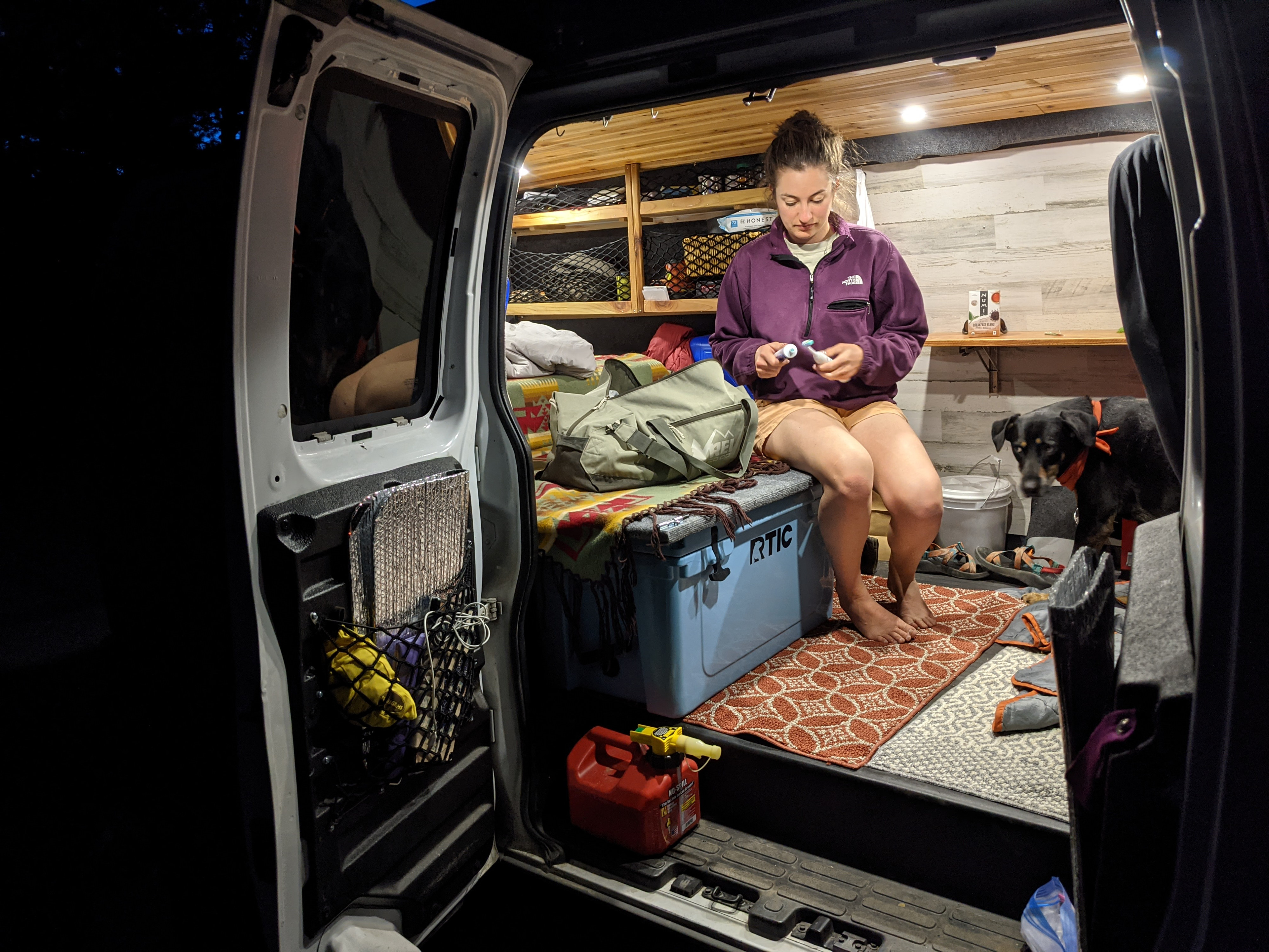 Woman and dog in a cozy RV rental camper van.. Gmc Savanna 2007