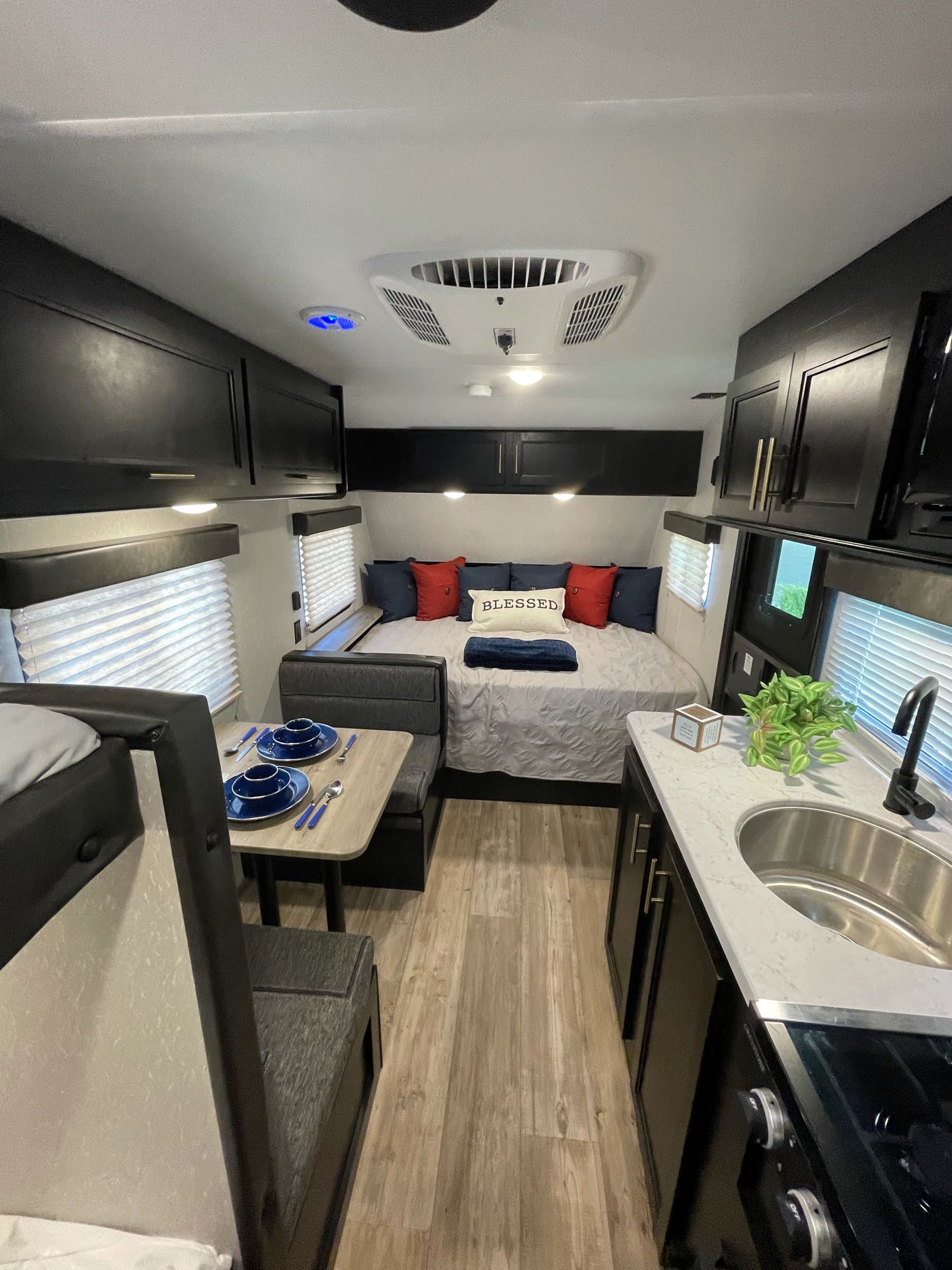 Experience compact living in this RV rental! Features a bed, dinette, and kitchen with modern finishes.. Forest River Wolf Den 16EV 2021