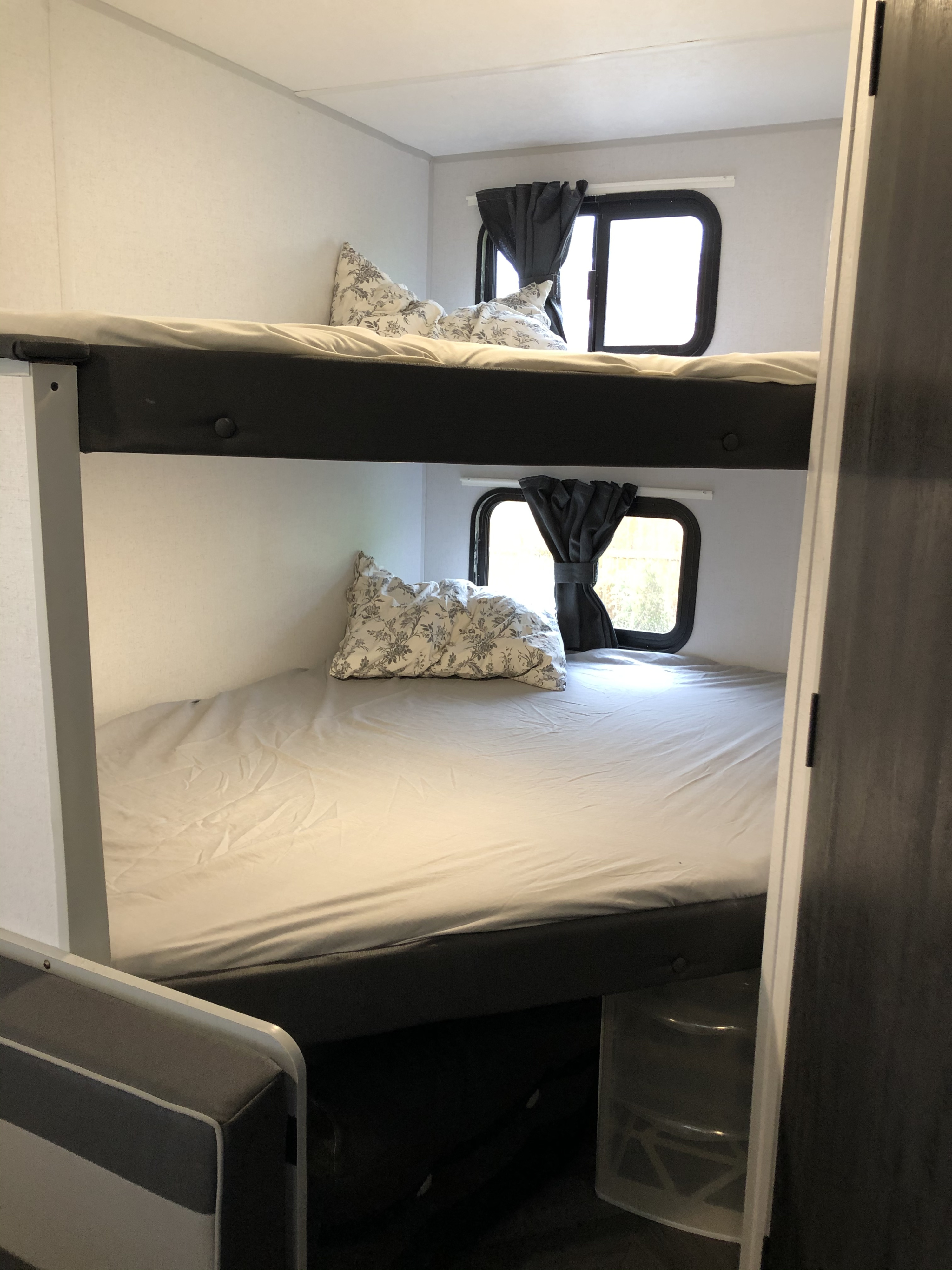 RV rental interior: Two bunk beds with pillows and windows, providing compact sleeping space.. Forest River Other 2021