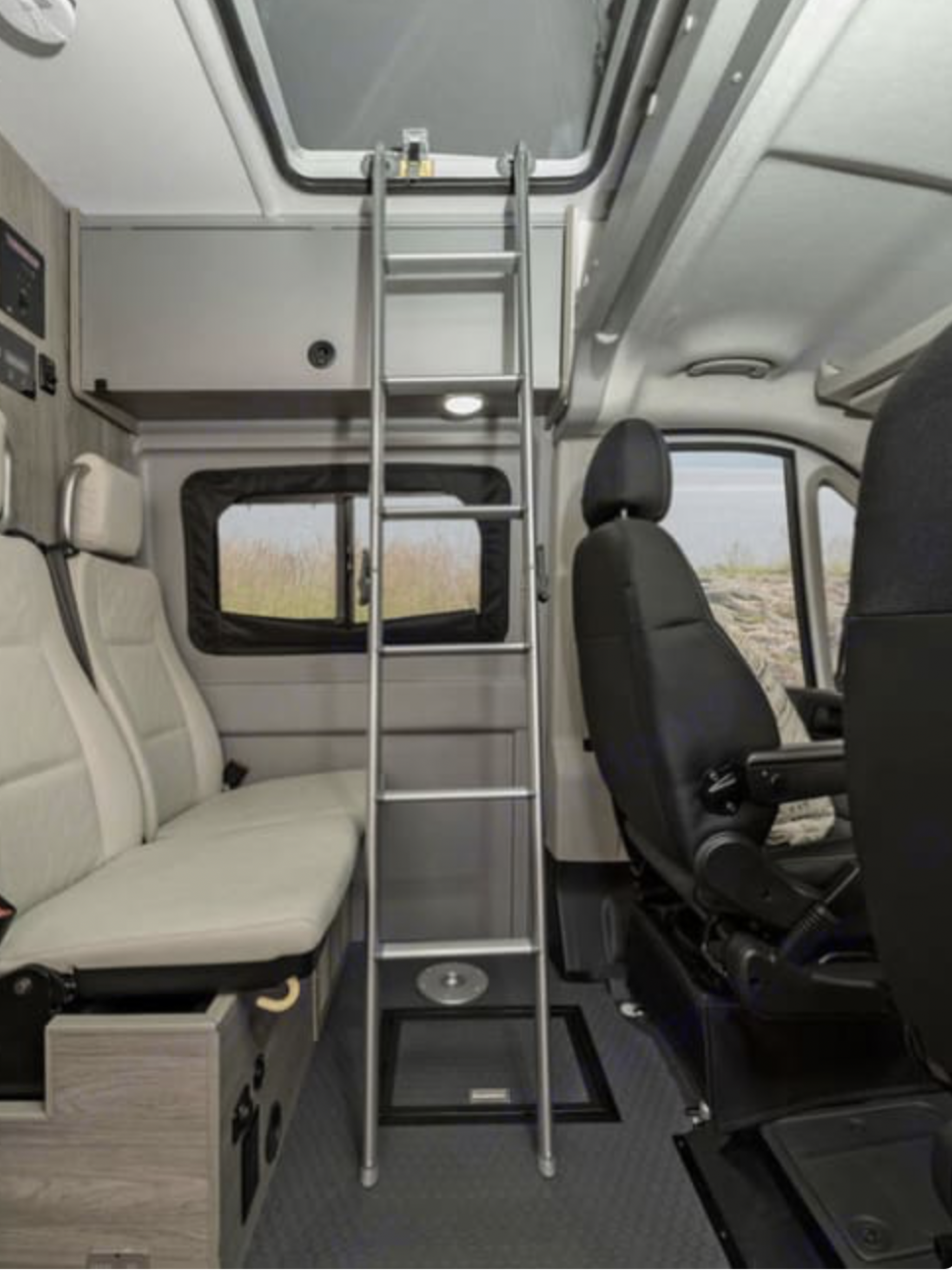 RV rental interior with a ladder leading to a raised roof access. Features include passenger seating, driver's seat, & overhead storage.. Winnebago Other 2022
