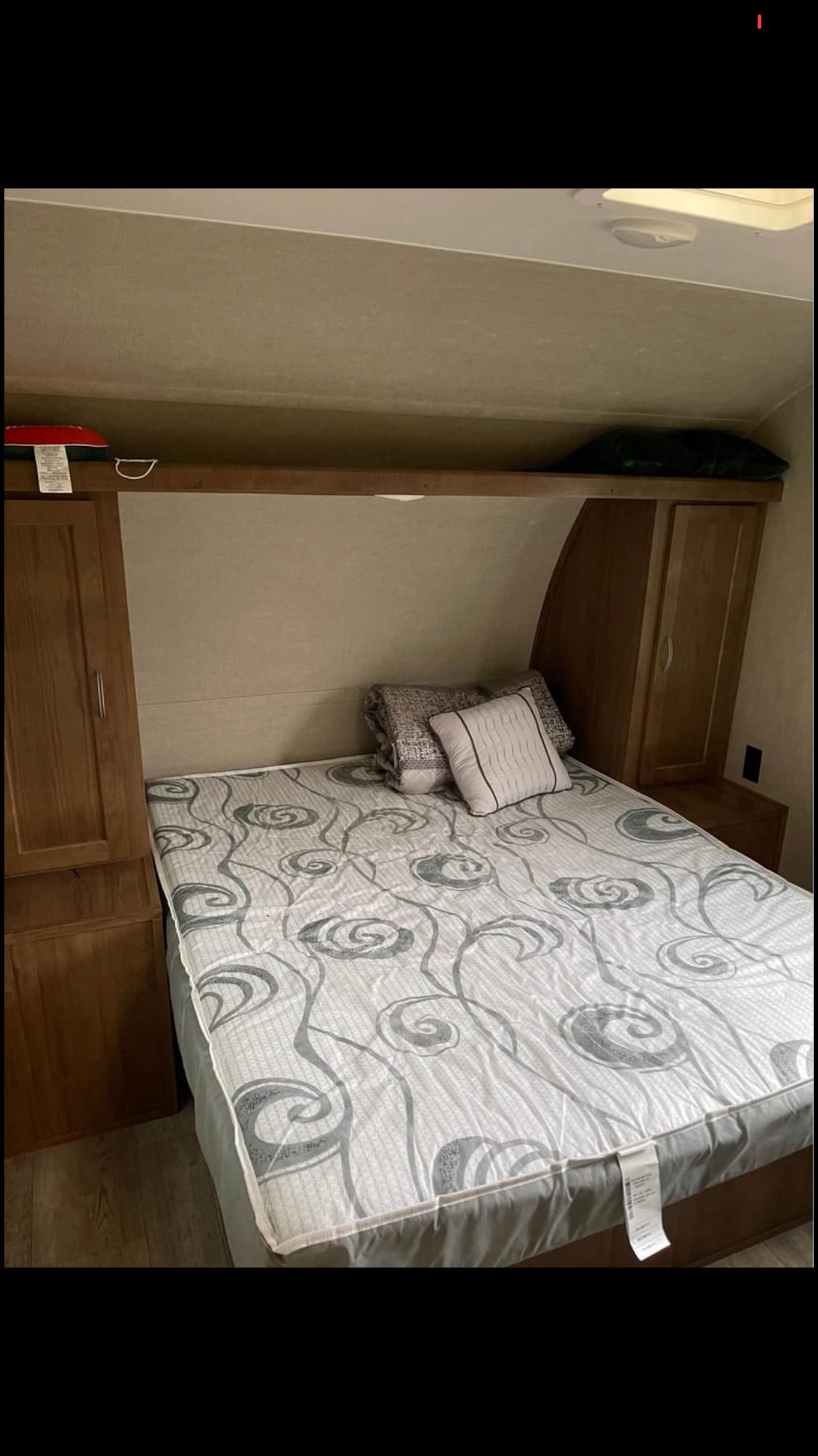 Cozy RV rental bedroom with comfortable bed, overhead shelf, and cabinet storage. Ready for your next trip.. Gulf Stream Amerilite 2018