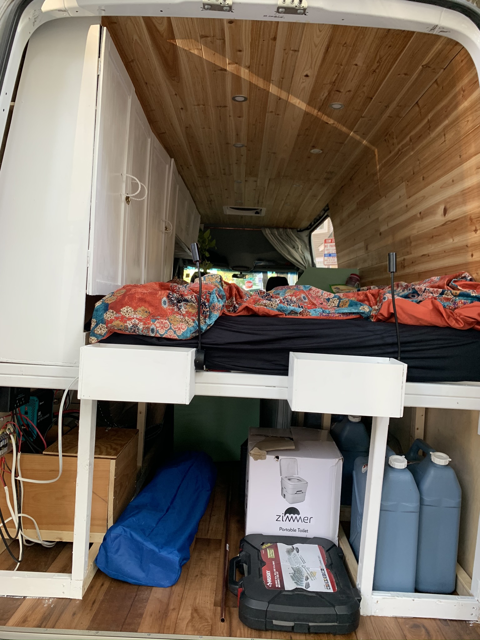 We stored bikes, skis, camping supplies, and extra water under the raised bed.. Mercedes-Benz Sprinter 2013
