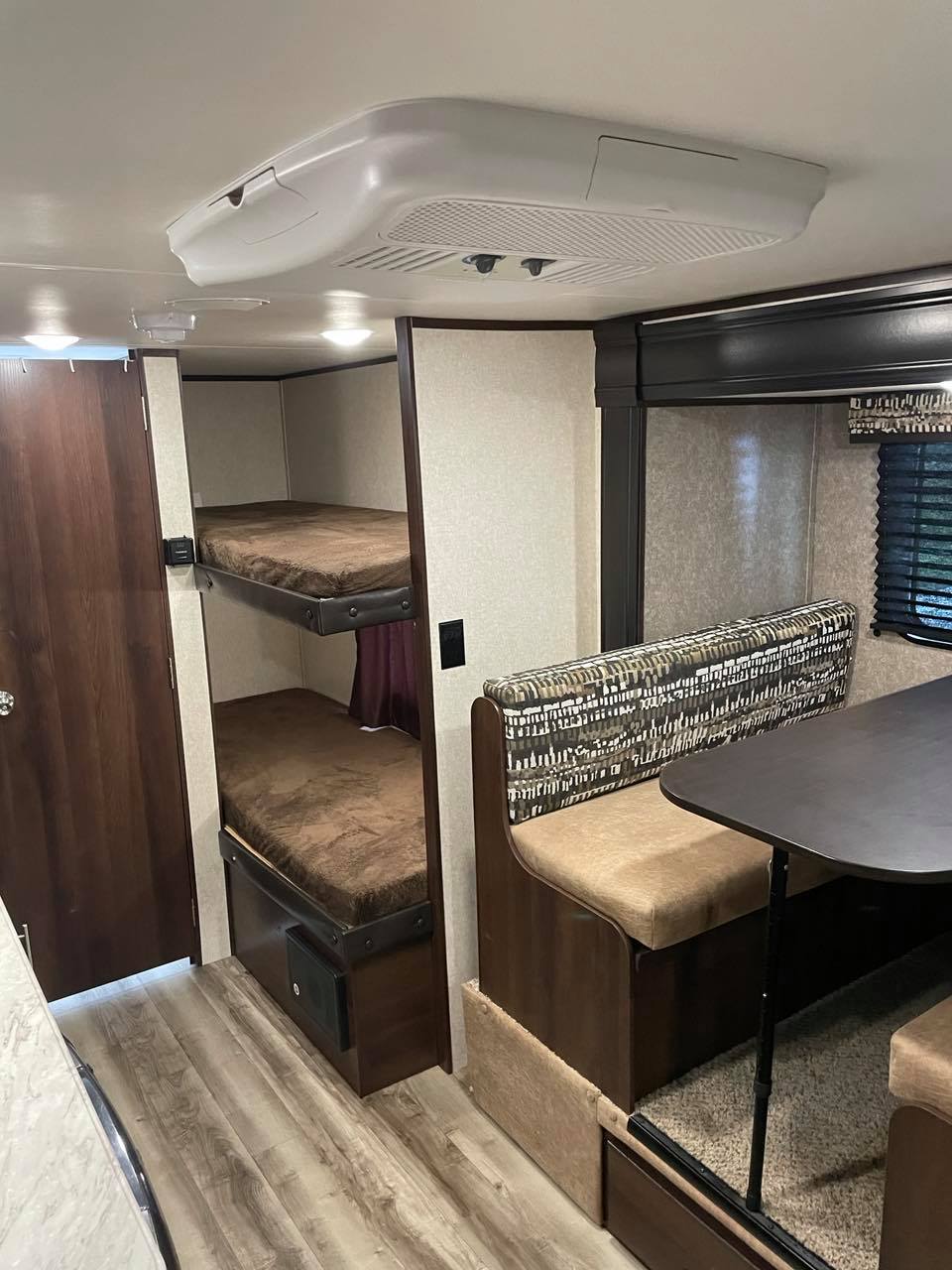 RV rental interior features bunk beds, a dinette, and AC, offering a comfortable living and sleeping space.. Jayco Jay Flight 2020