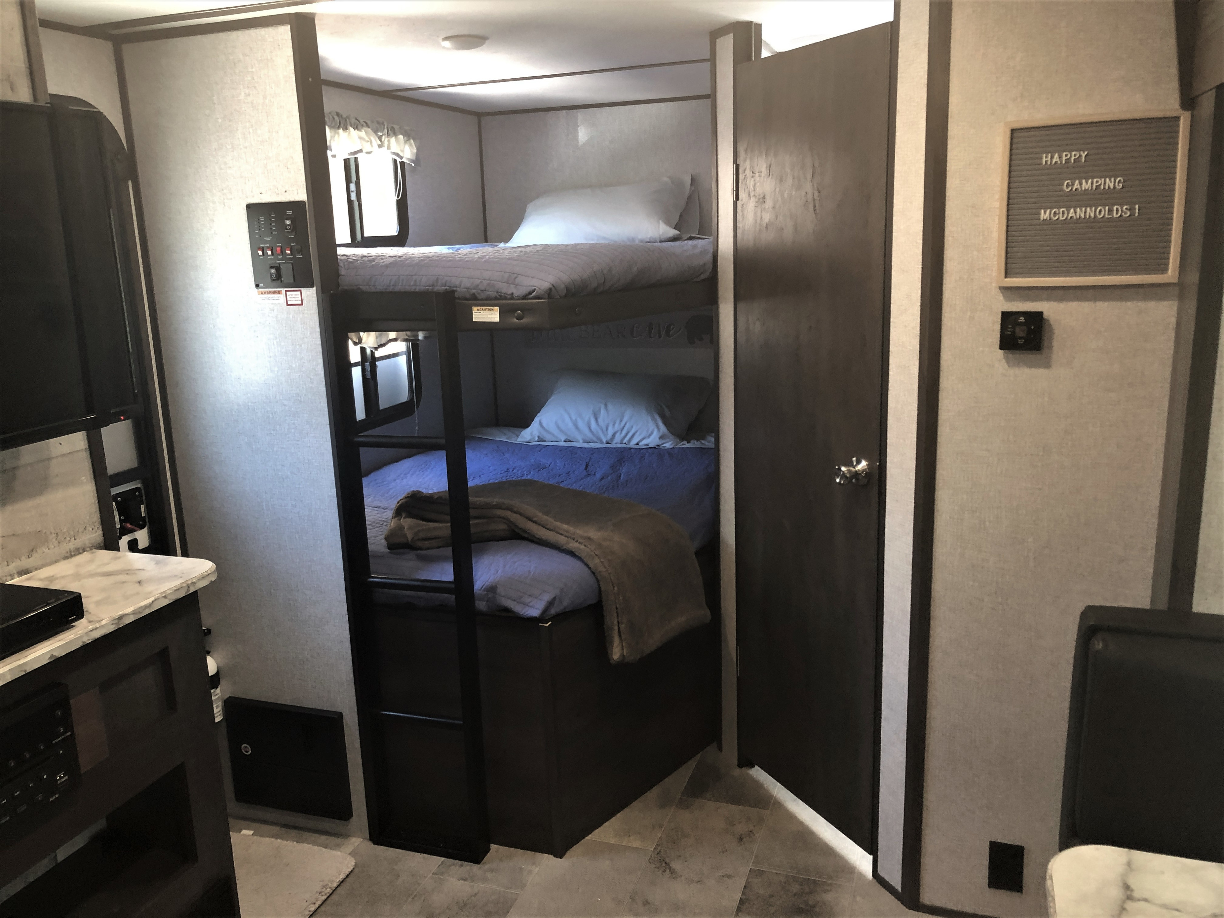 Two double-sized bunk beds with stationary ladder and under-bed storage. Dutchmen Coleman Light 2020