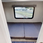 RV rental interior: A cozy sleeping area with two mattresses and a window showing the outdoors, perfect for camping trips.. Coachmen Mirada A-Class 2022