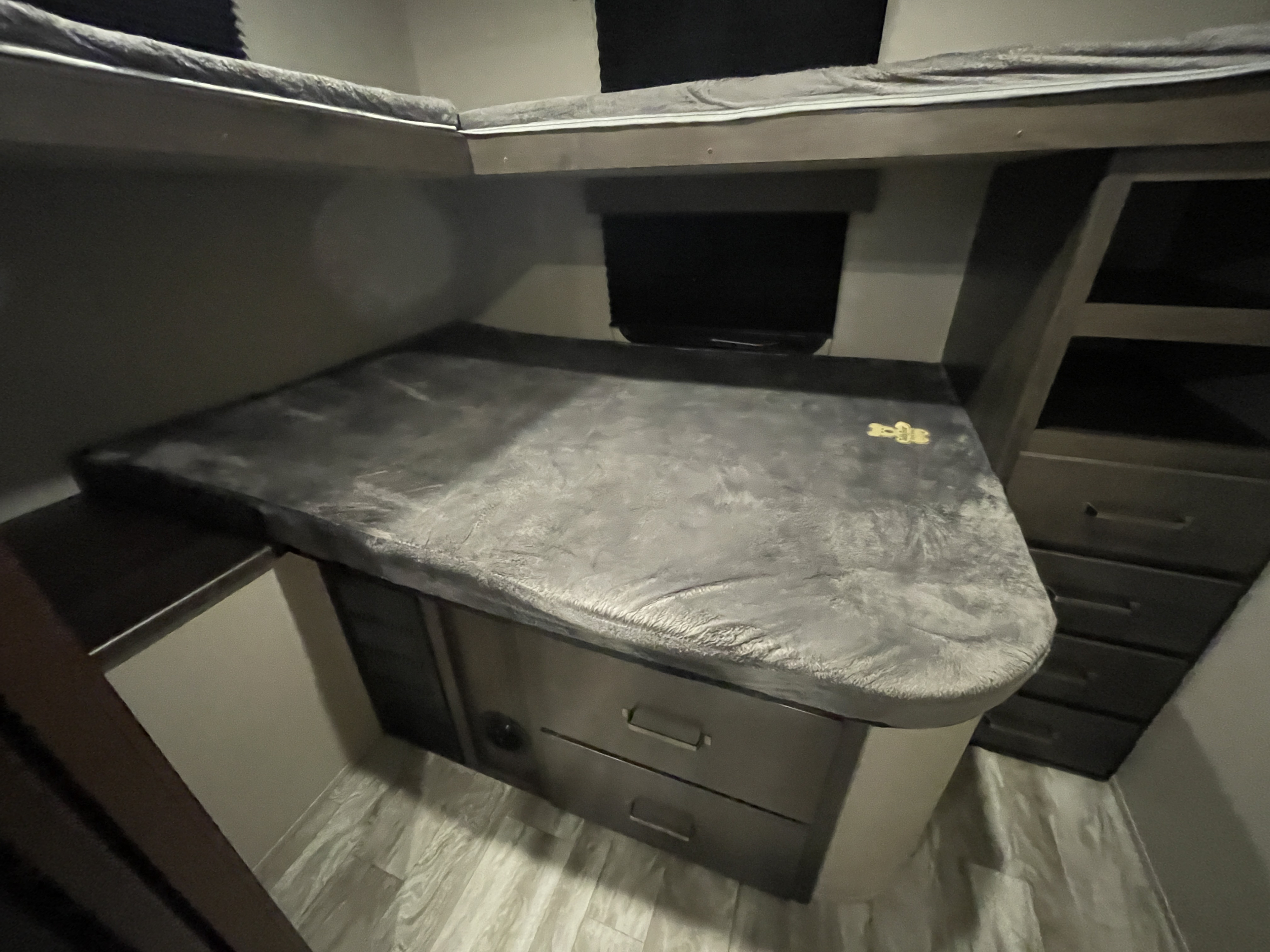 Spacious RV rental bunk beds with built-in storage, a lower seating/sleeping area, and TV. Ready for your adventure!. Grand Design Transcend 2021