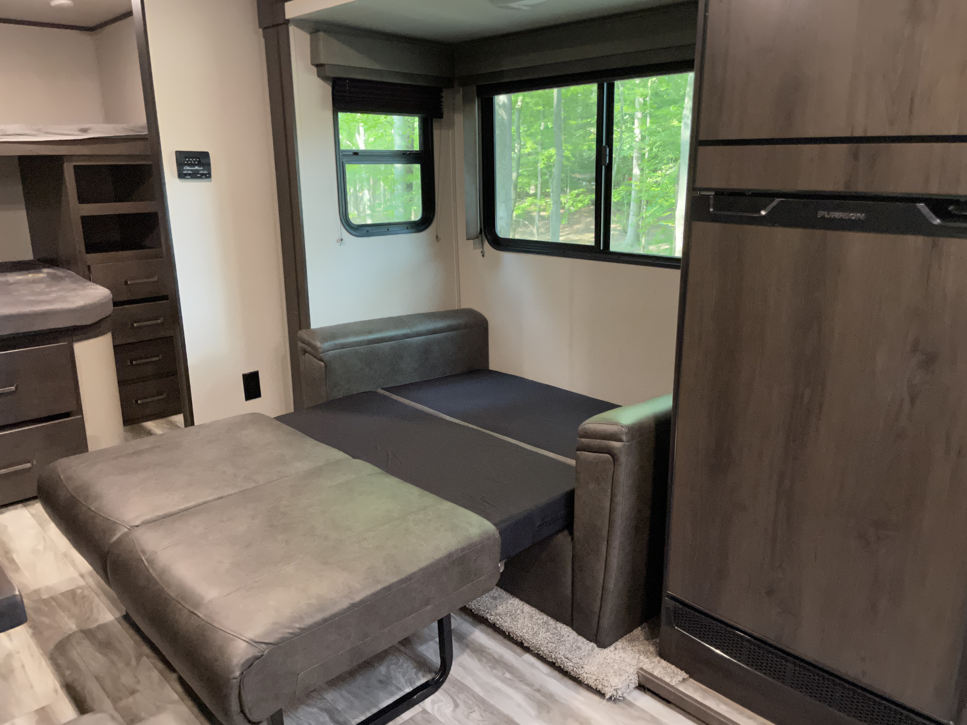 This **RV rental** features a convertible sofa bed, bunk beds, and fridge, offering versatile living space.. Grand Design Transcend 2021