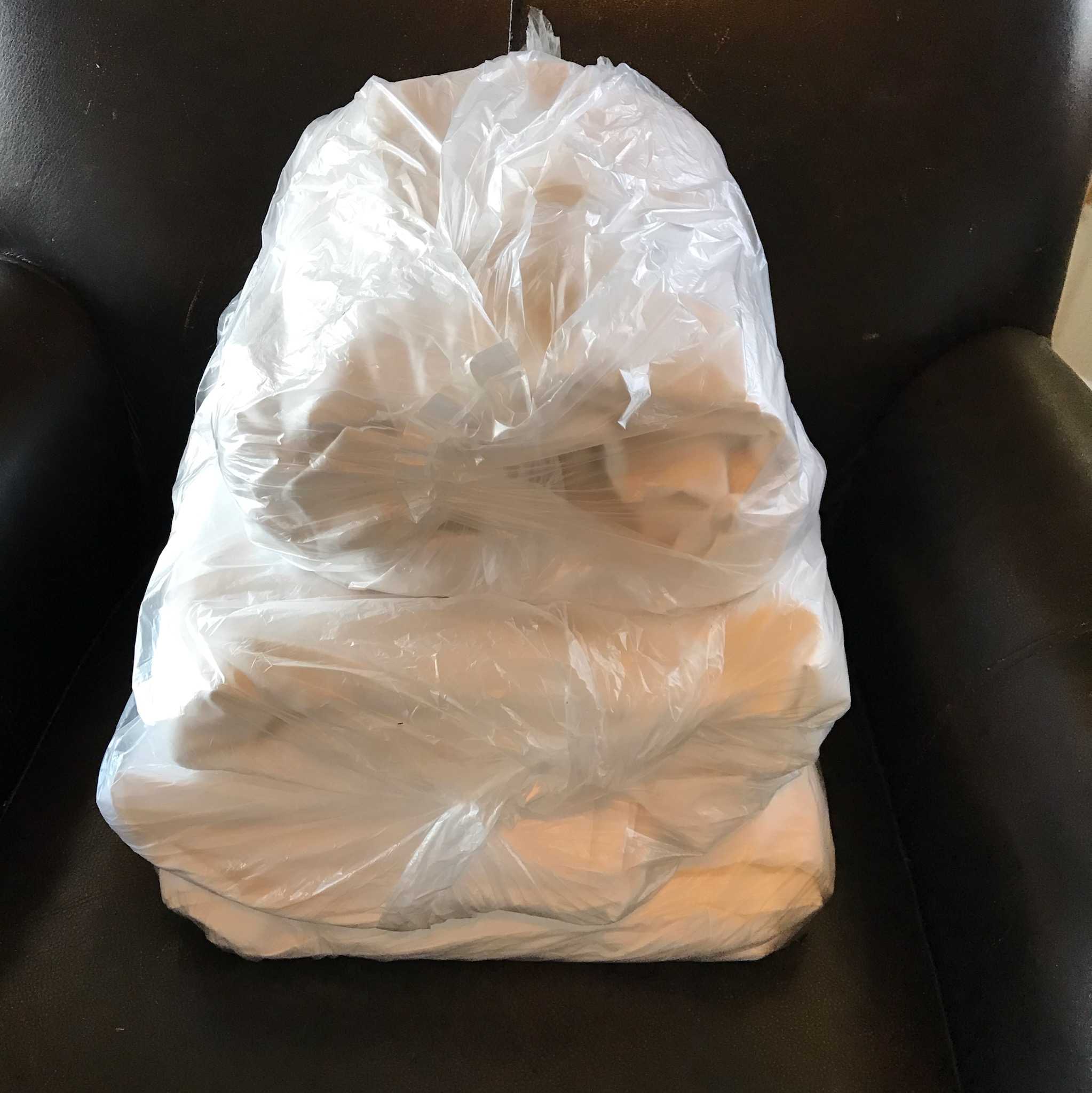 Prepped fresh linens in a clear bag on a dark chair, ready for your comfortable RV rental.. Winnebago Minnie Winnie 2022