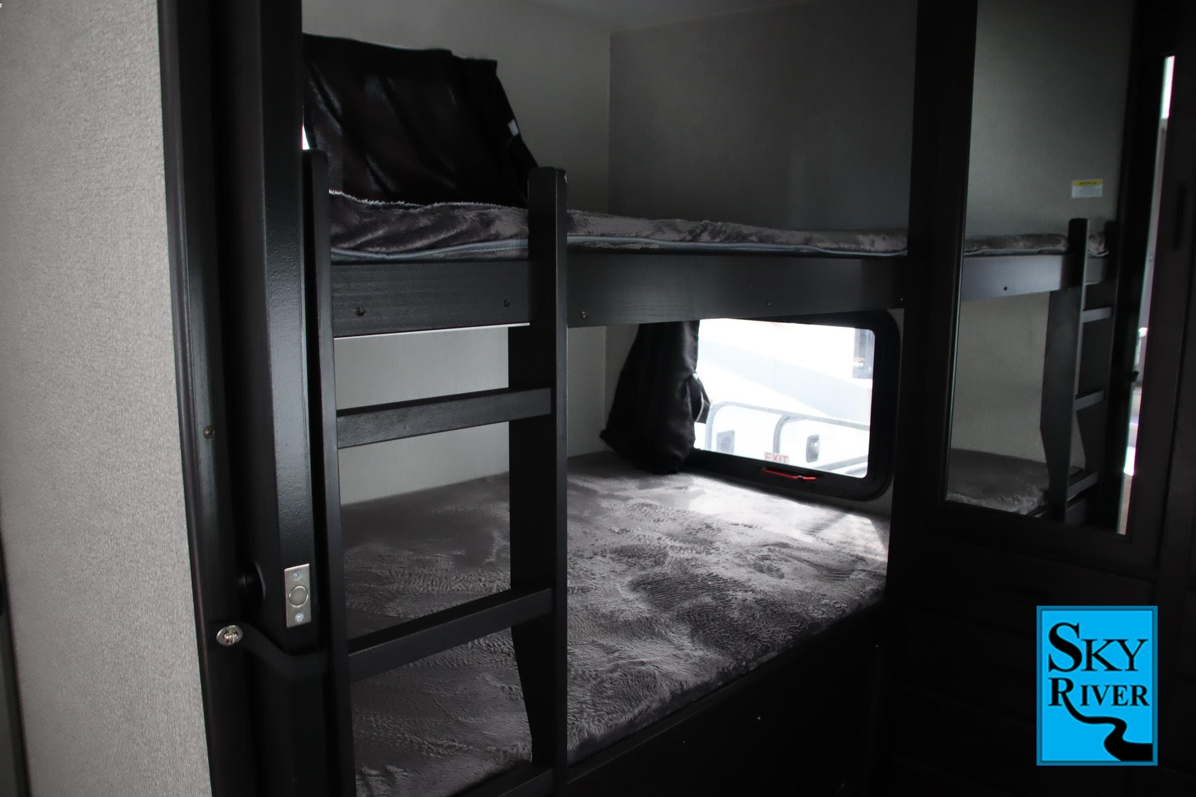 RV rental bunk room: Dark-framed beds with cozy grey bedding, a window, perfect for family trips.. Starcraft Telluride 2021