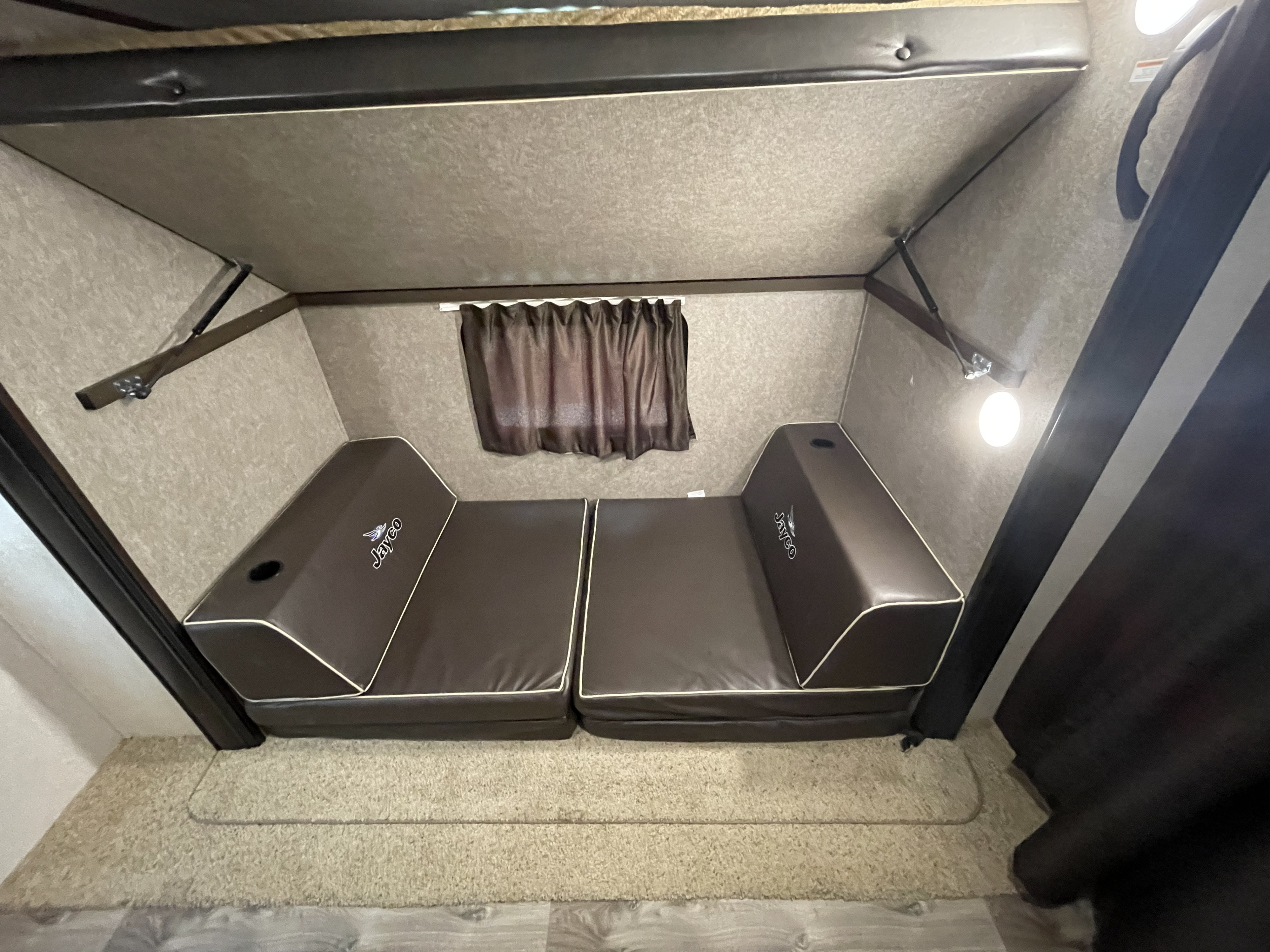 This RV rental's interior features Jayco convertible seating, ideal for a comfortable bunk or lounge space.. Jayco Flight SLX 2018