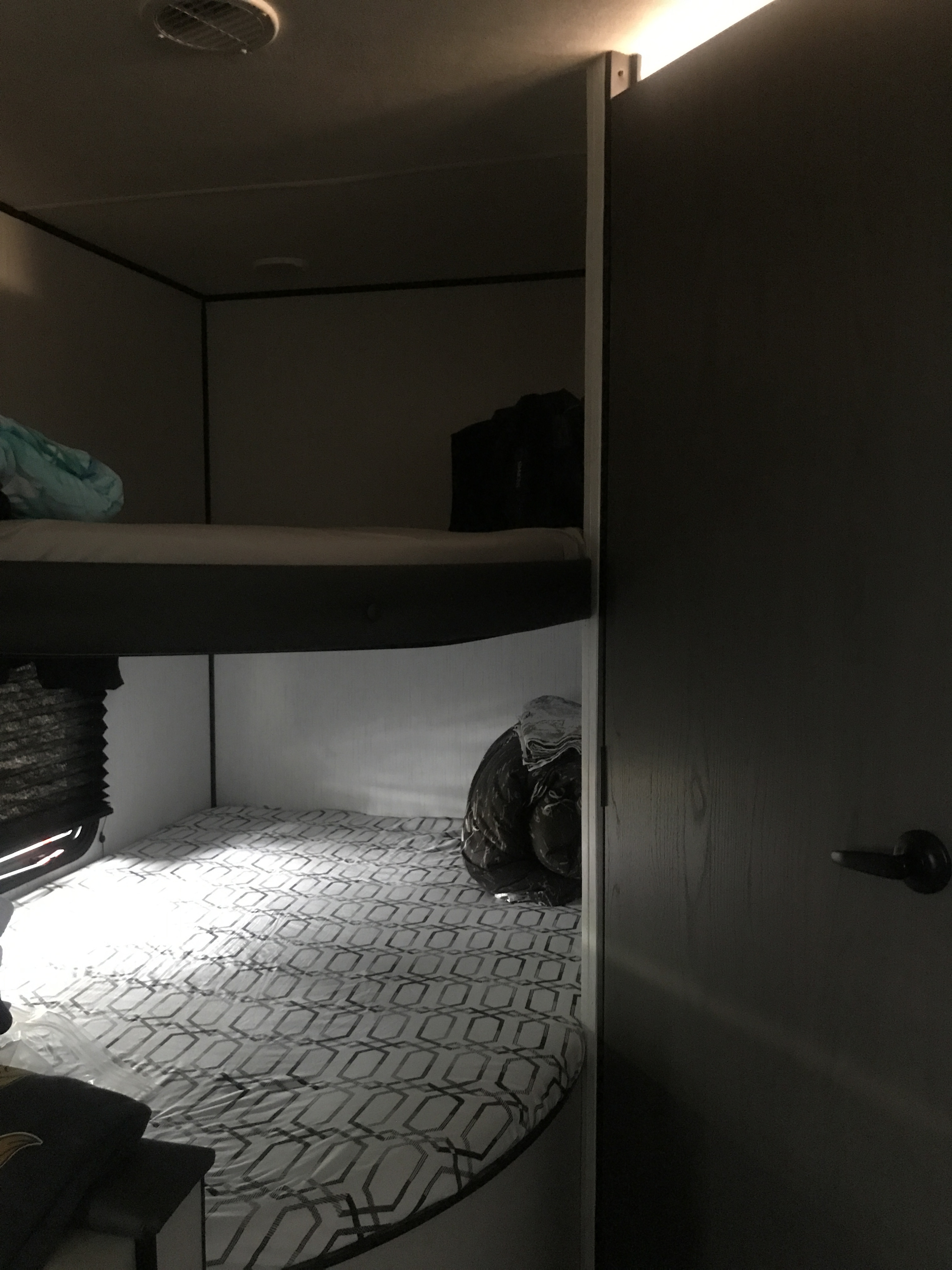 Inside this RV rental: cozy bunk beds, upper and lower, perfect for family travel. Compact and functional interior sleeping area.. Heartland Prowler 2021