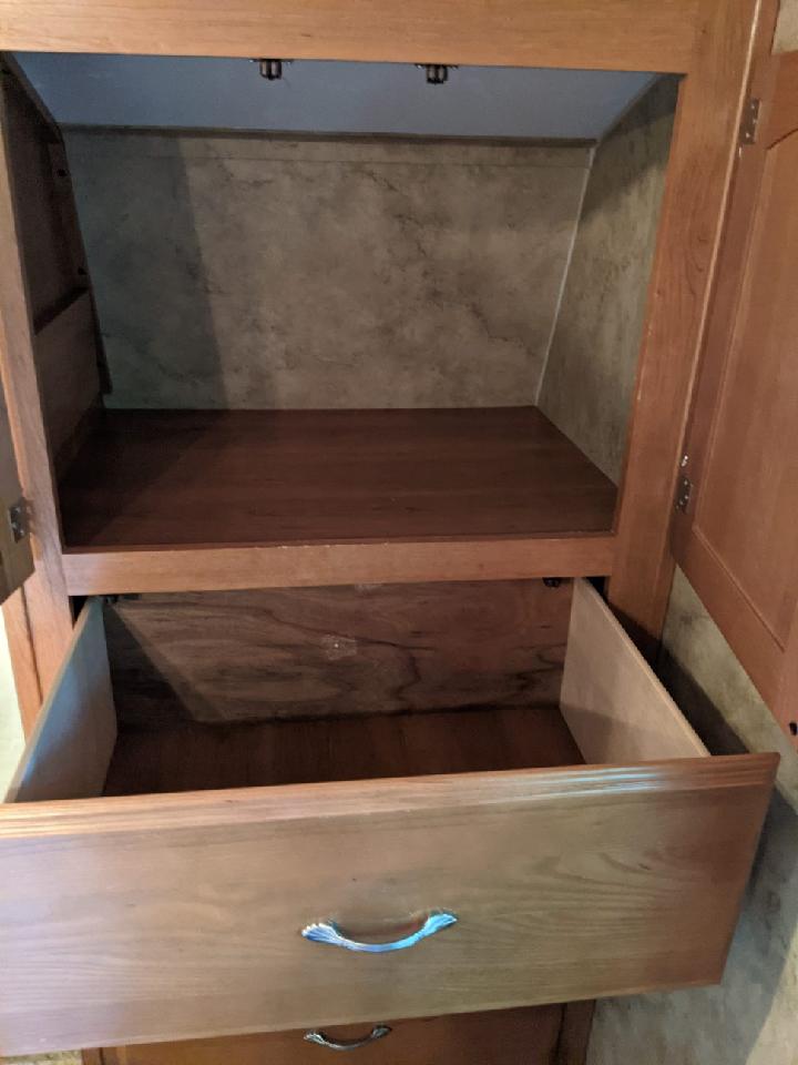 RV rental: view inside a clean, open cabinet with a pull-out drawer, ready for your travel essentials.. Keystone Cougar 2009