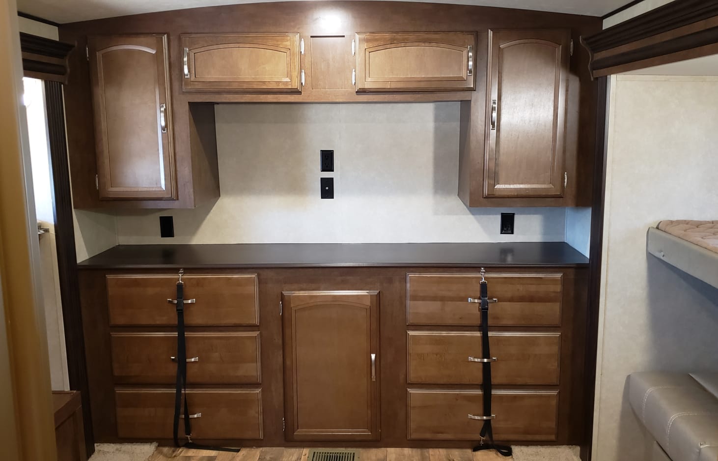 RV rental interior with built-in cabinetry, drawers, and counter, offering ample storage for a comfortable stay.. Forest River Wildwood Heritage Glen Lite 2016
