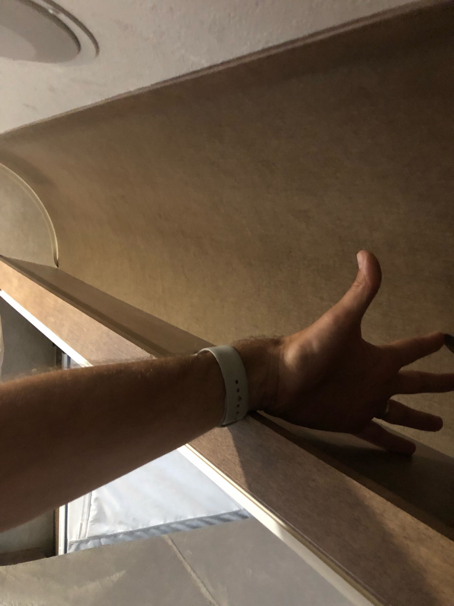 Checking the overhead cabinet space in an RV rental. A person's arm extends into the light wood-toned interior.. Starcraft Launch 2018