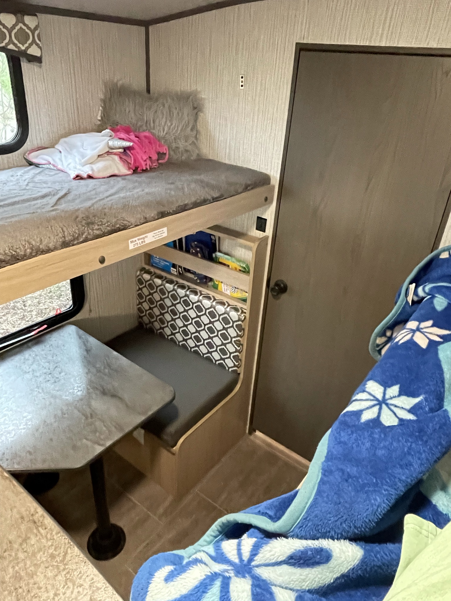 Cozy RV rental interior with bunk bed (275lb limit), dinette, and door. Perfect for family camping trips.. Cruiser Rv Corp Radiance 2021