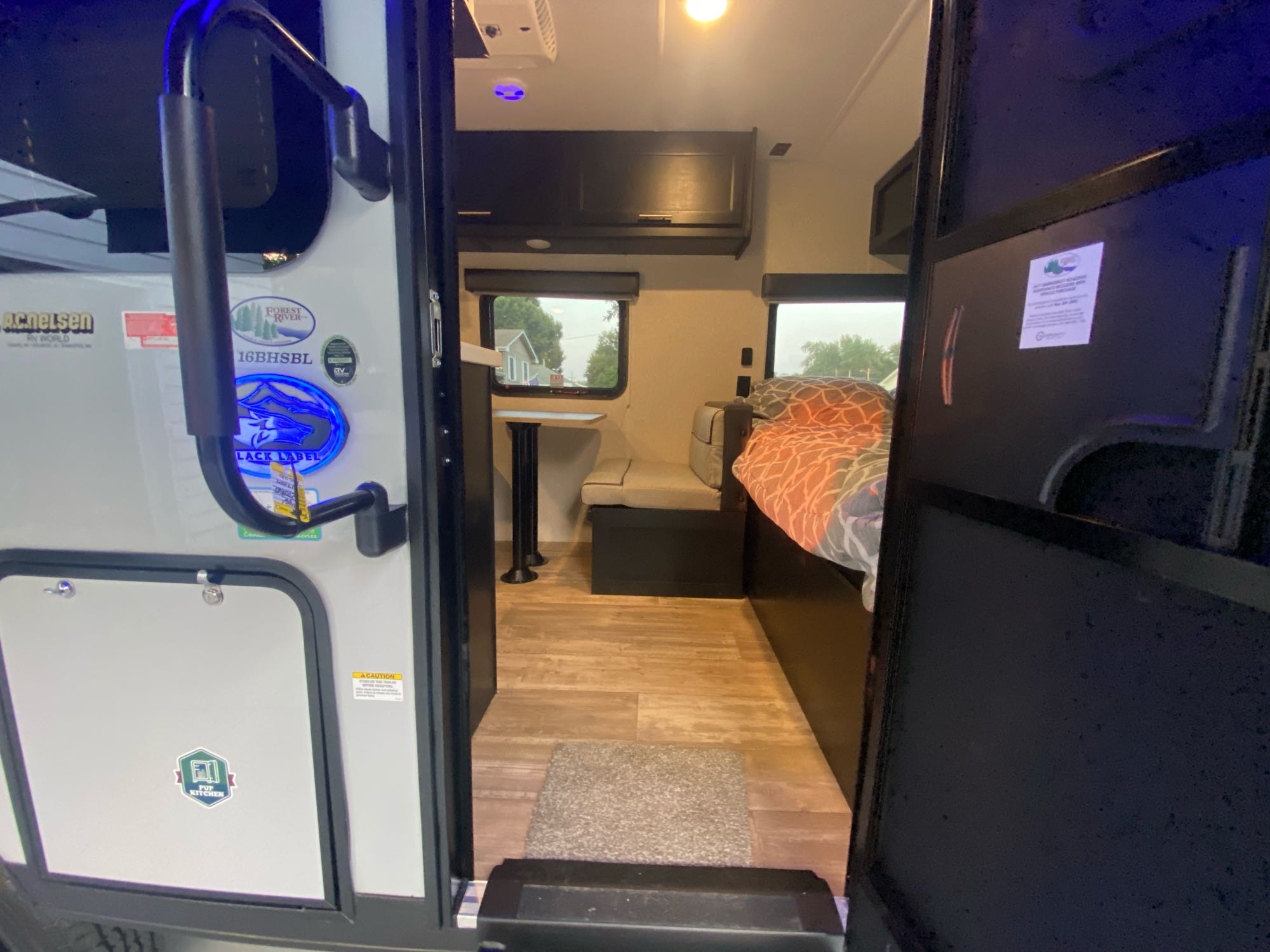 Step inside this RV rental: a glimpse of a Forest River travel trailer with dinette, bed, and exterior FUP Kitchen access.. Forest River Other 2021