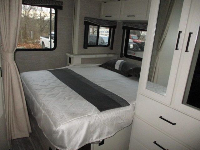 RV rental bedroom interior: cozy bed, window views, and ample storage. Ideal for comfortable travel.. Thor Motor Coach Four Winds 2021